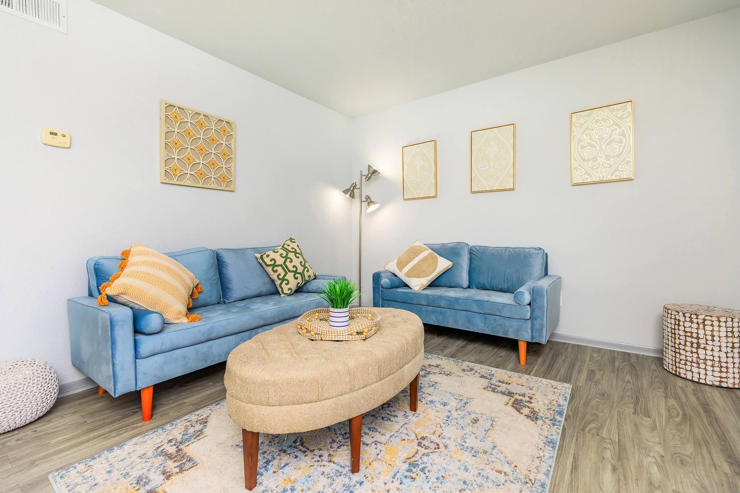 a living room filled with furniture and a tv