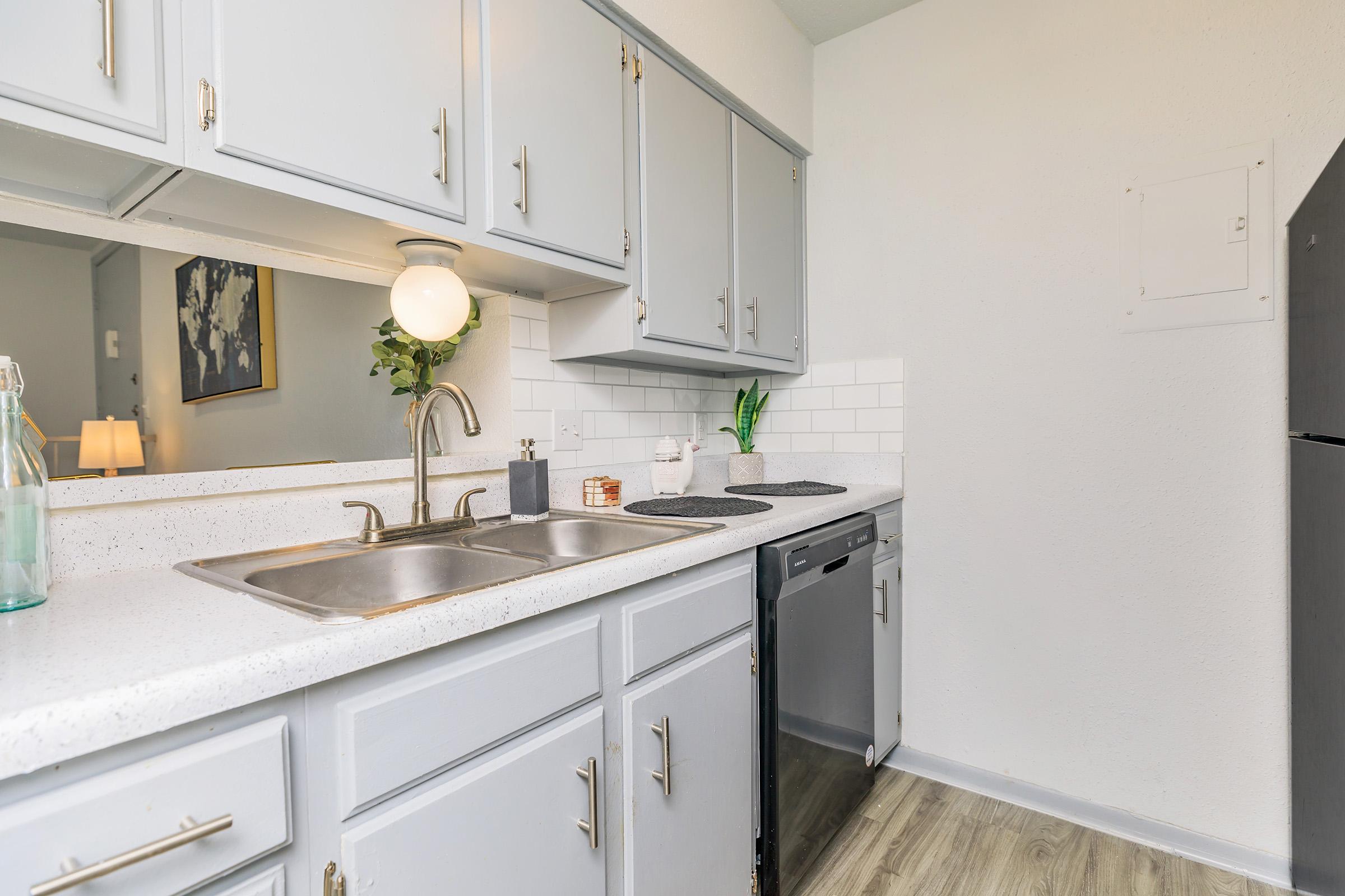 a kitchen with a sink and a refrigerator