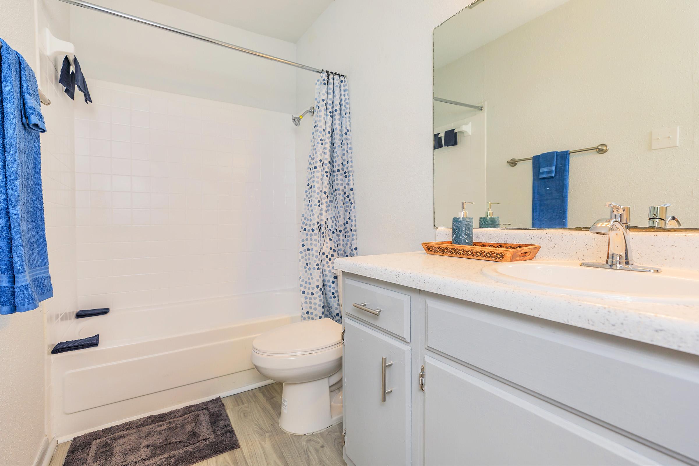 a room with a sink and a shower curtain