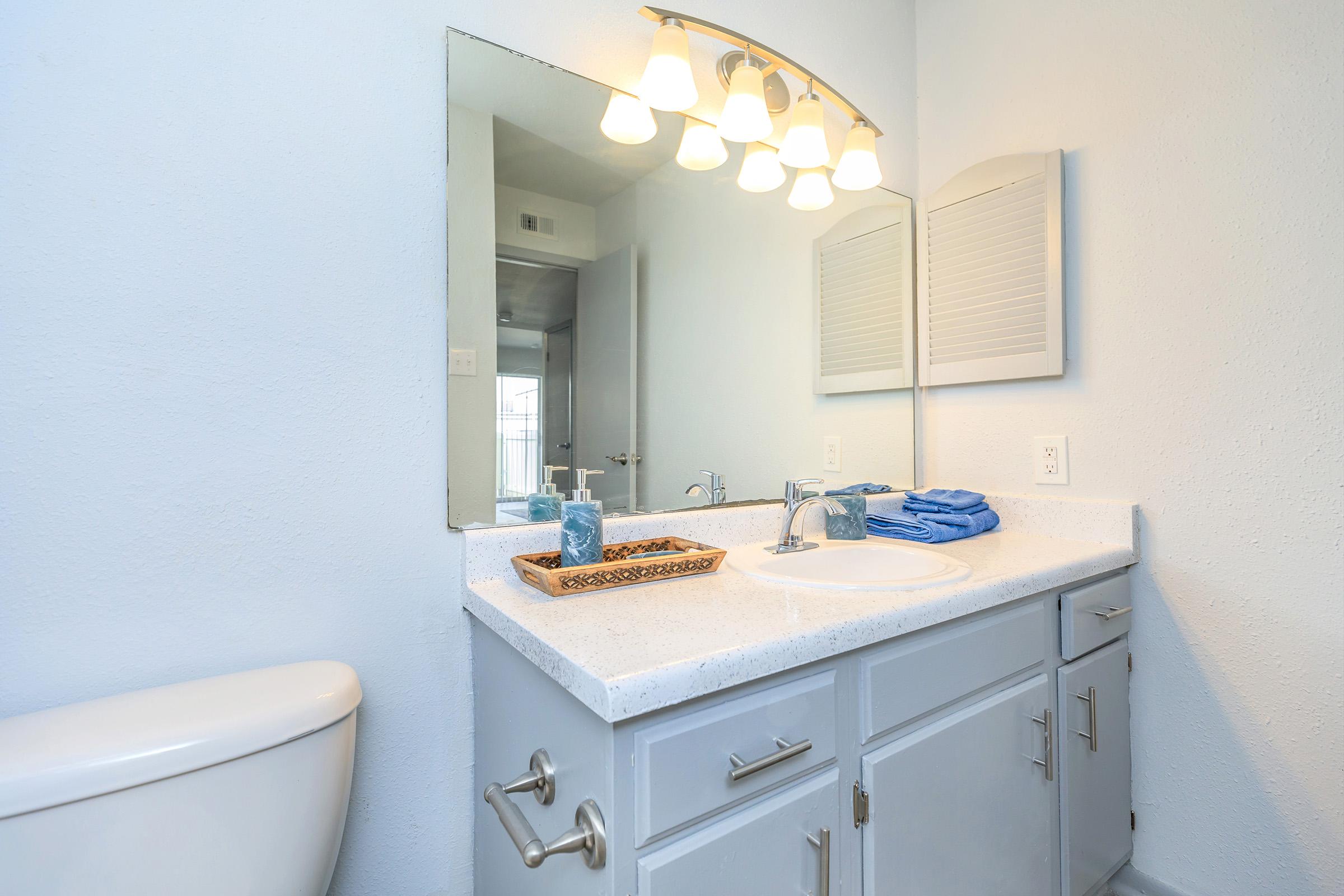 a kitchen with a sink and a mirror