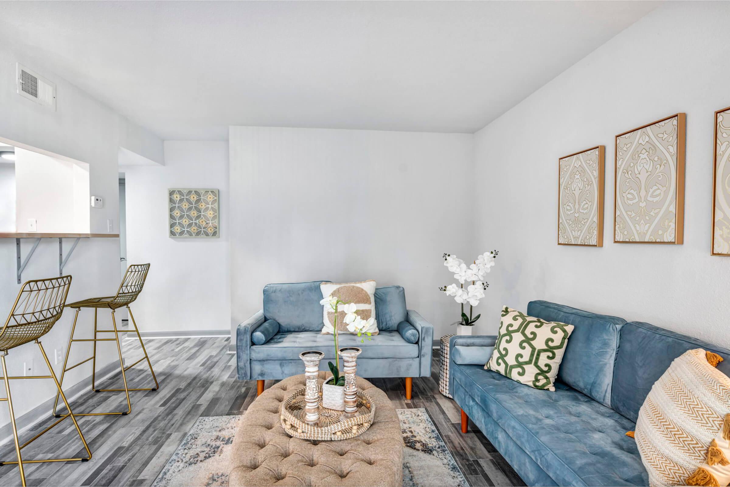 a living room filled with furniture and a bed