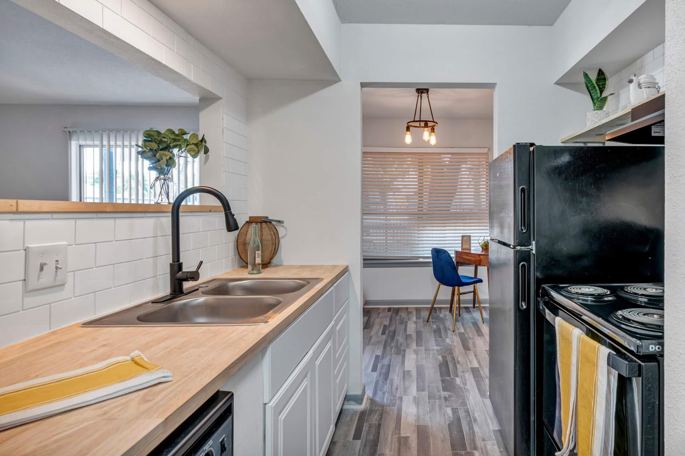 a modern kitchen with stainless steel appliances and wooden cabinets