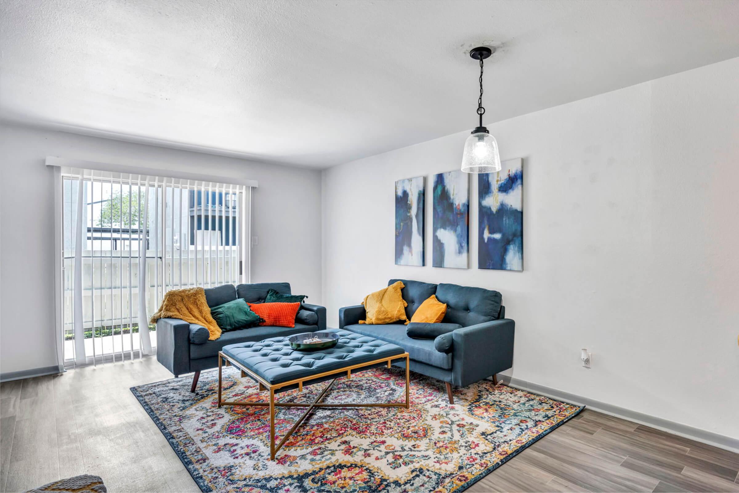 a living room filled with furniture and a rug