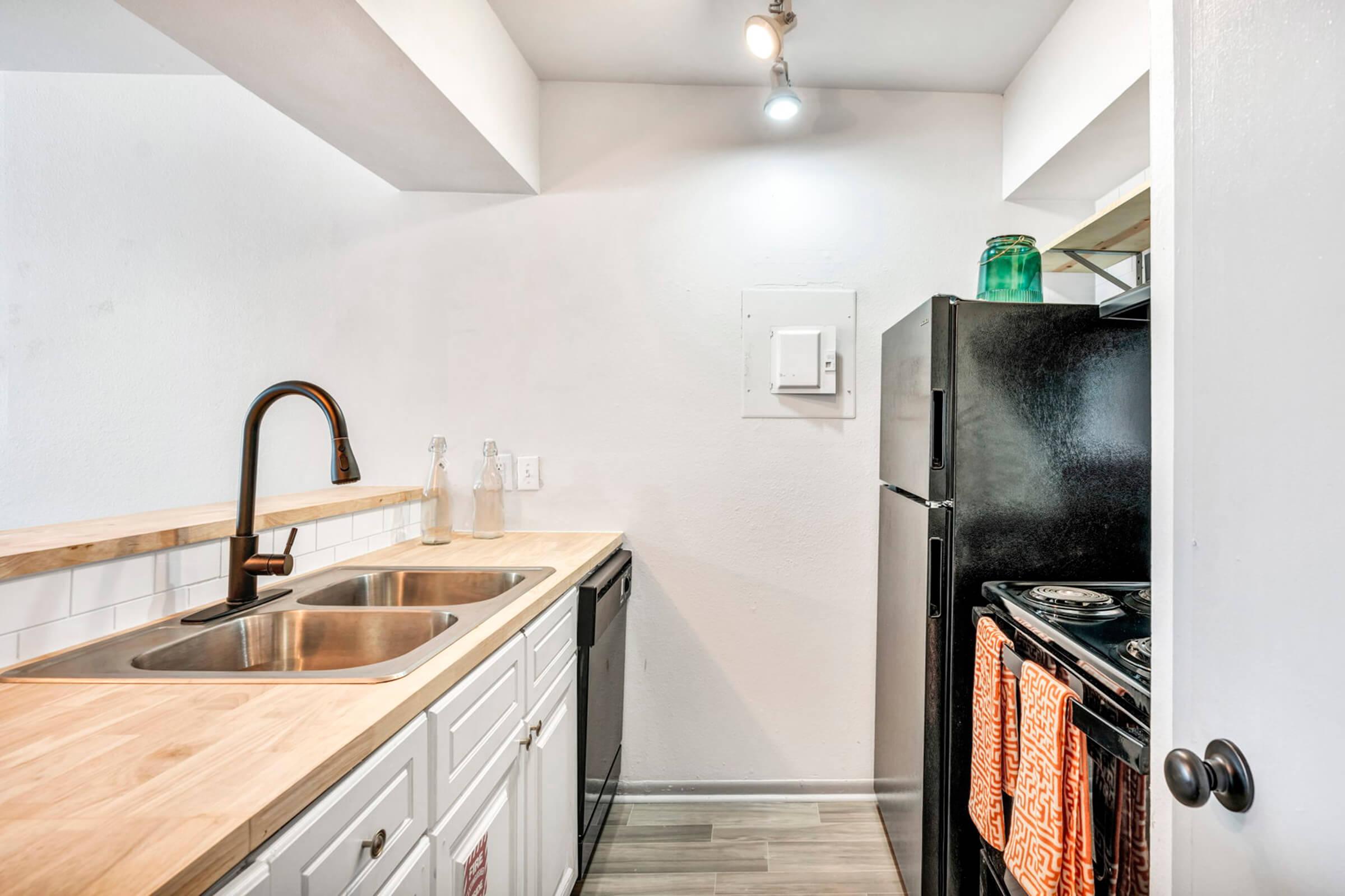 a kitchen with a sink and a refrigerator