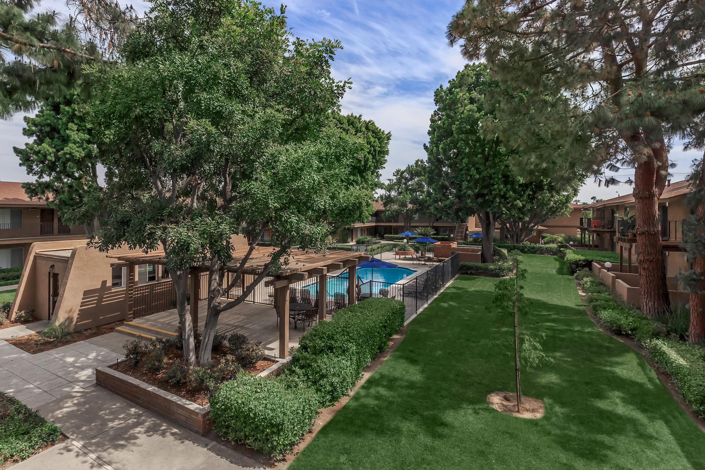 La Ramada Apartment Homes community pool with green landscaping