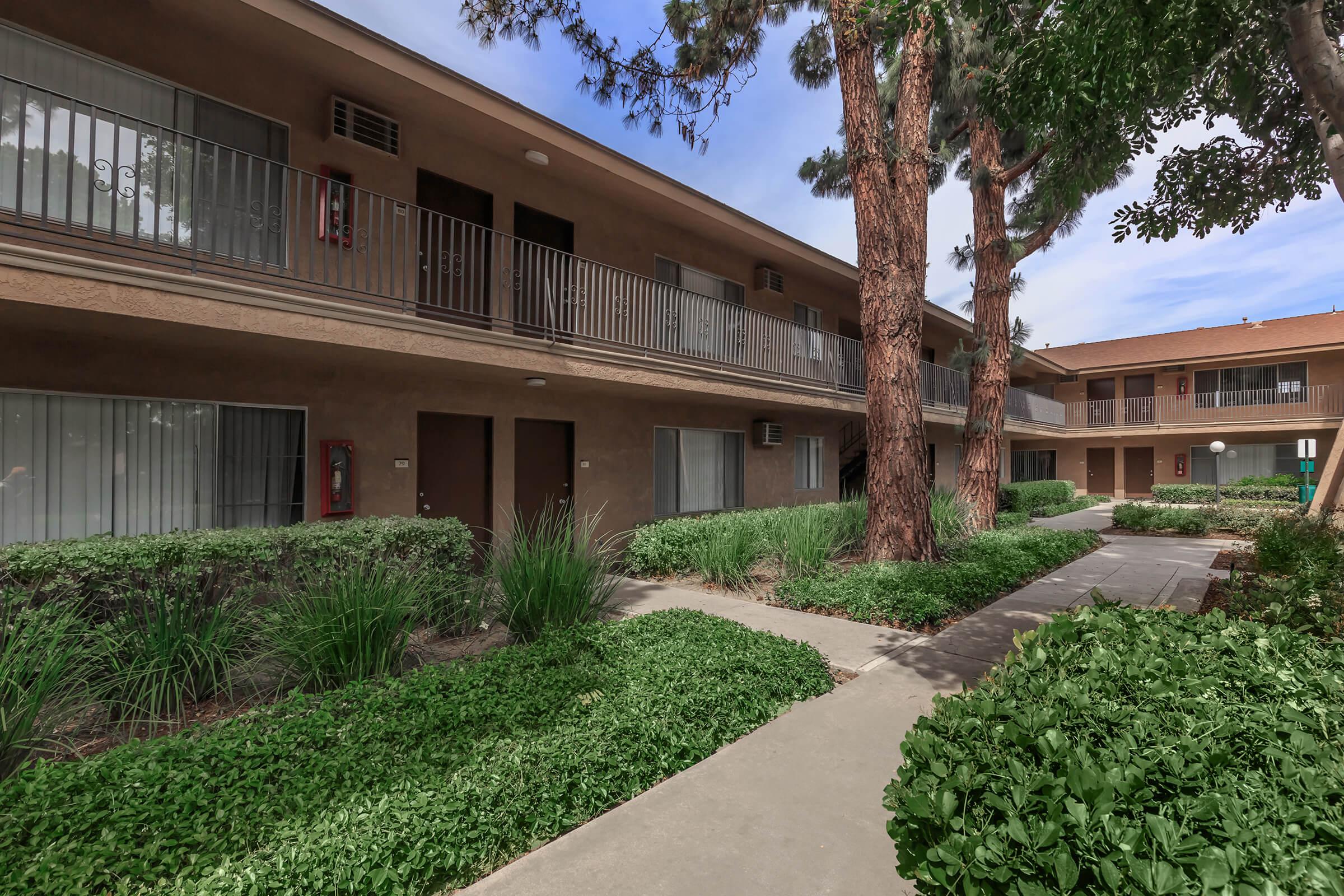 La Ramada Apartment Homes community building with green landscaping