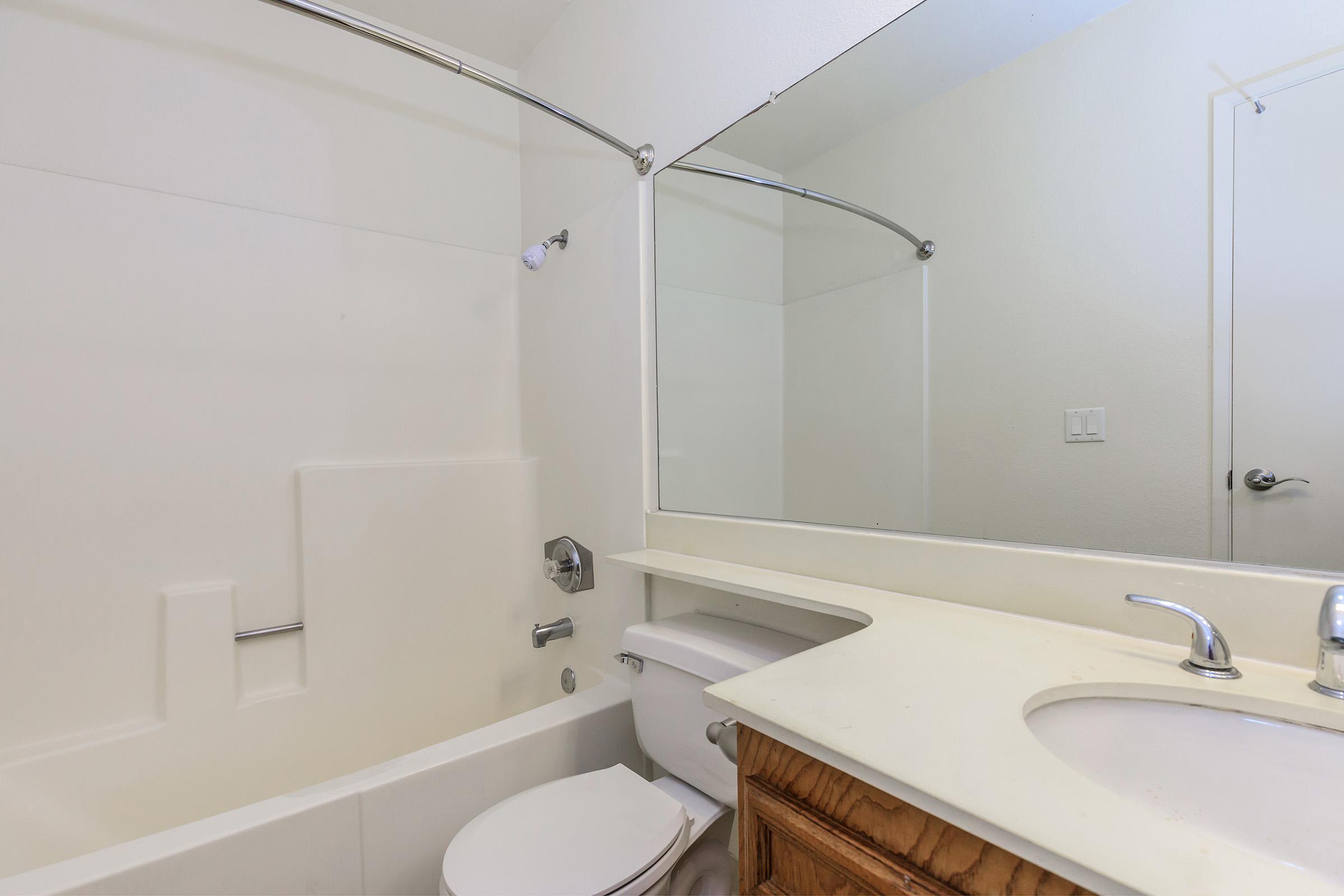 a large white tub sitting next to a sink