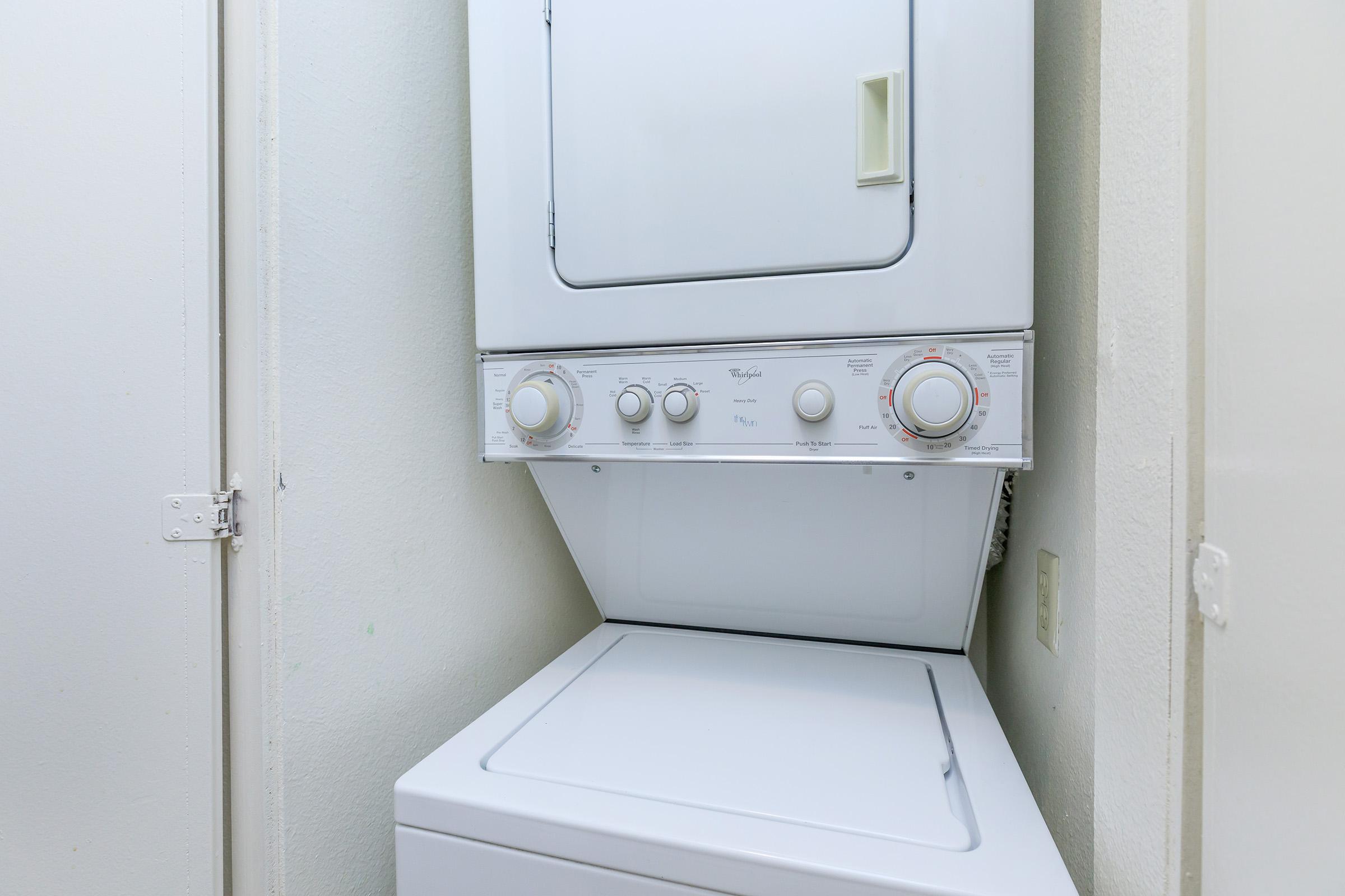 a white refrigerator freezer sitting next to a door