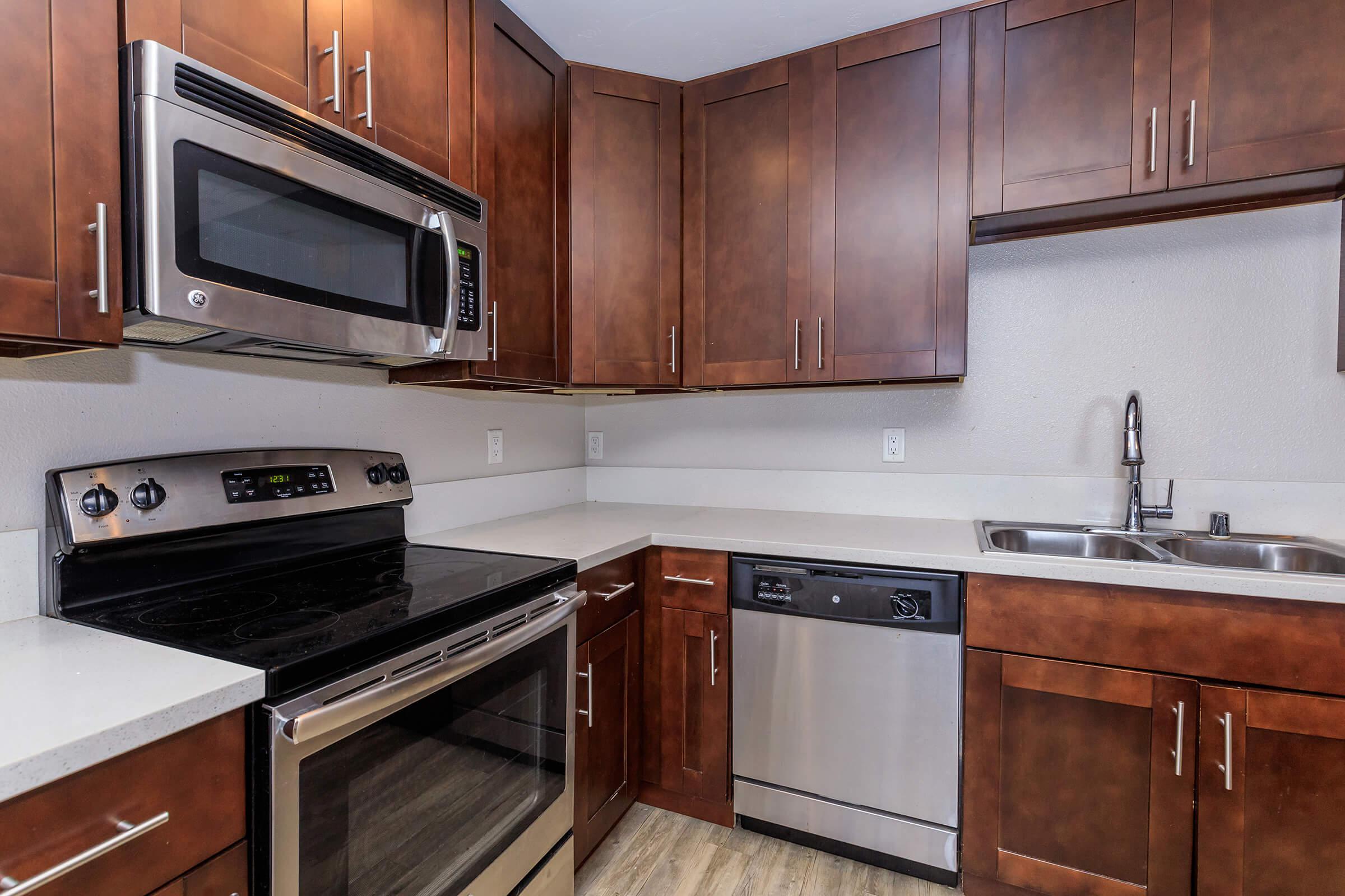 a kitchen with stainless steel appliances and wooden cabinets