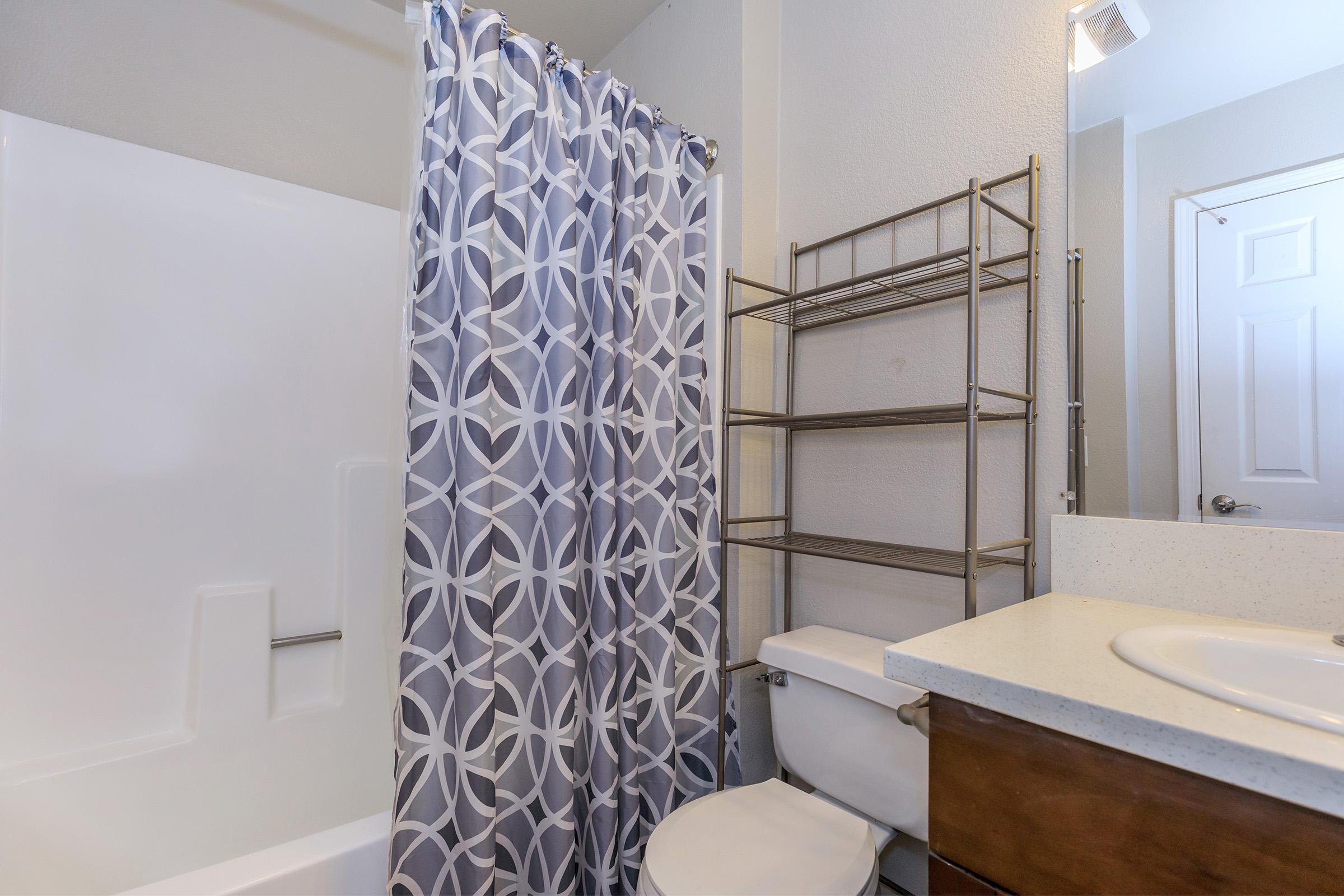 a large white tub next to a shower