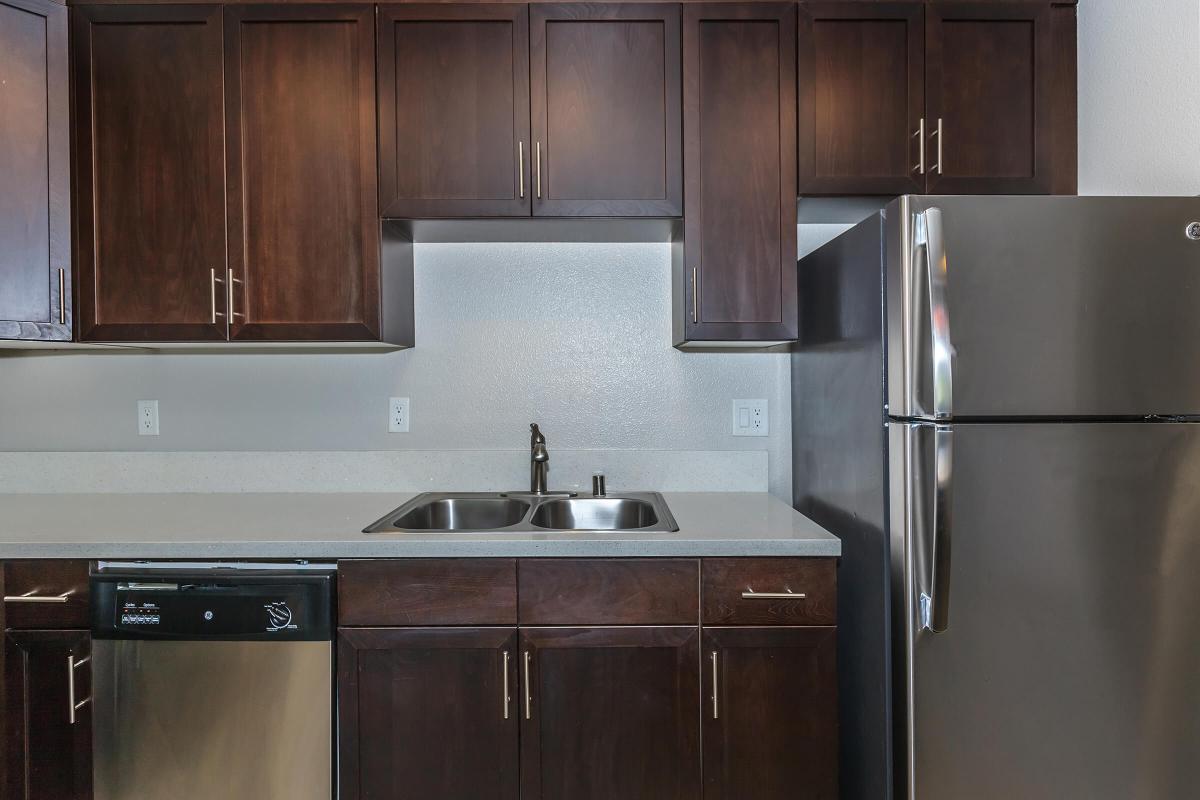 a kitchen with stainless steel appliances and wooden cabinets