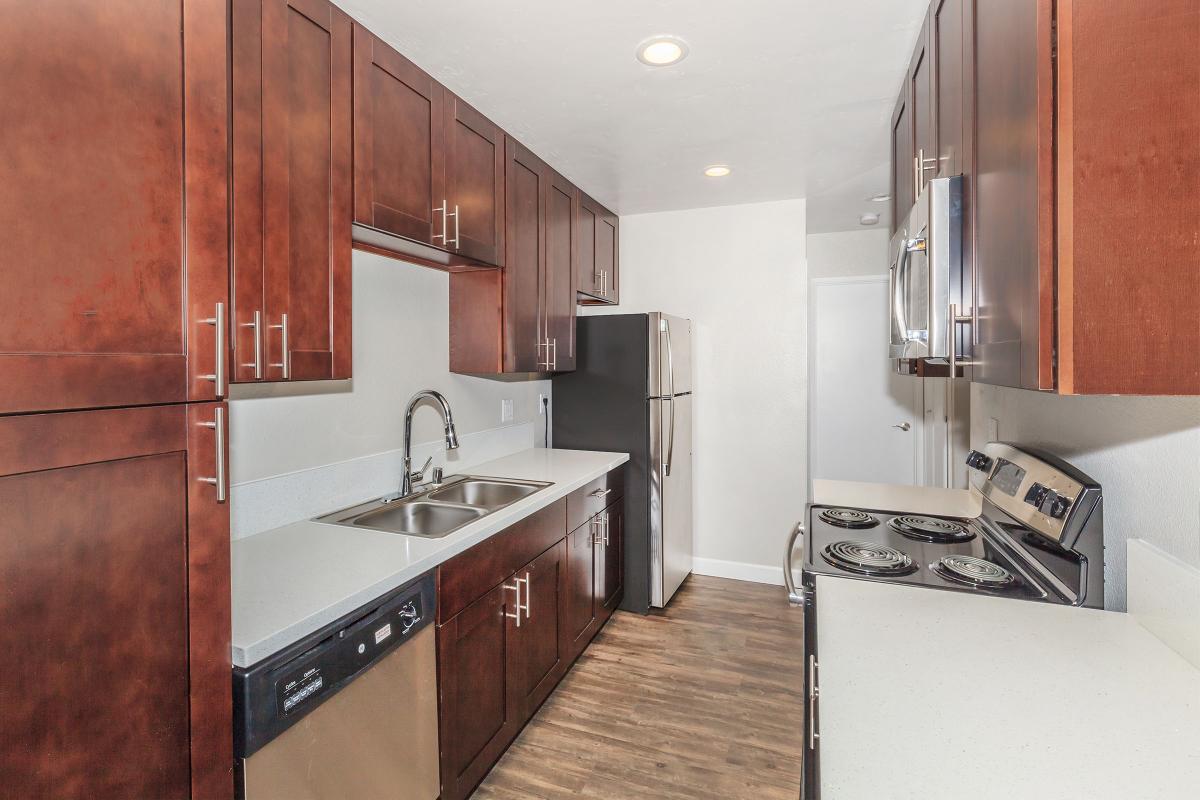 a kitchen with stainless steel appliances and wooden cabinets