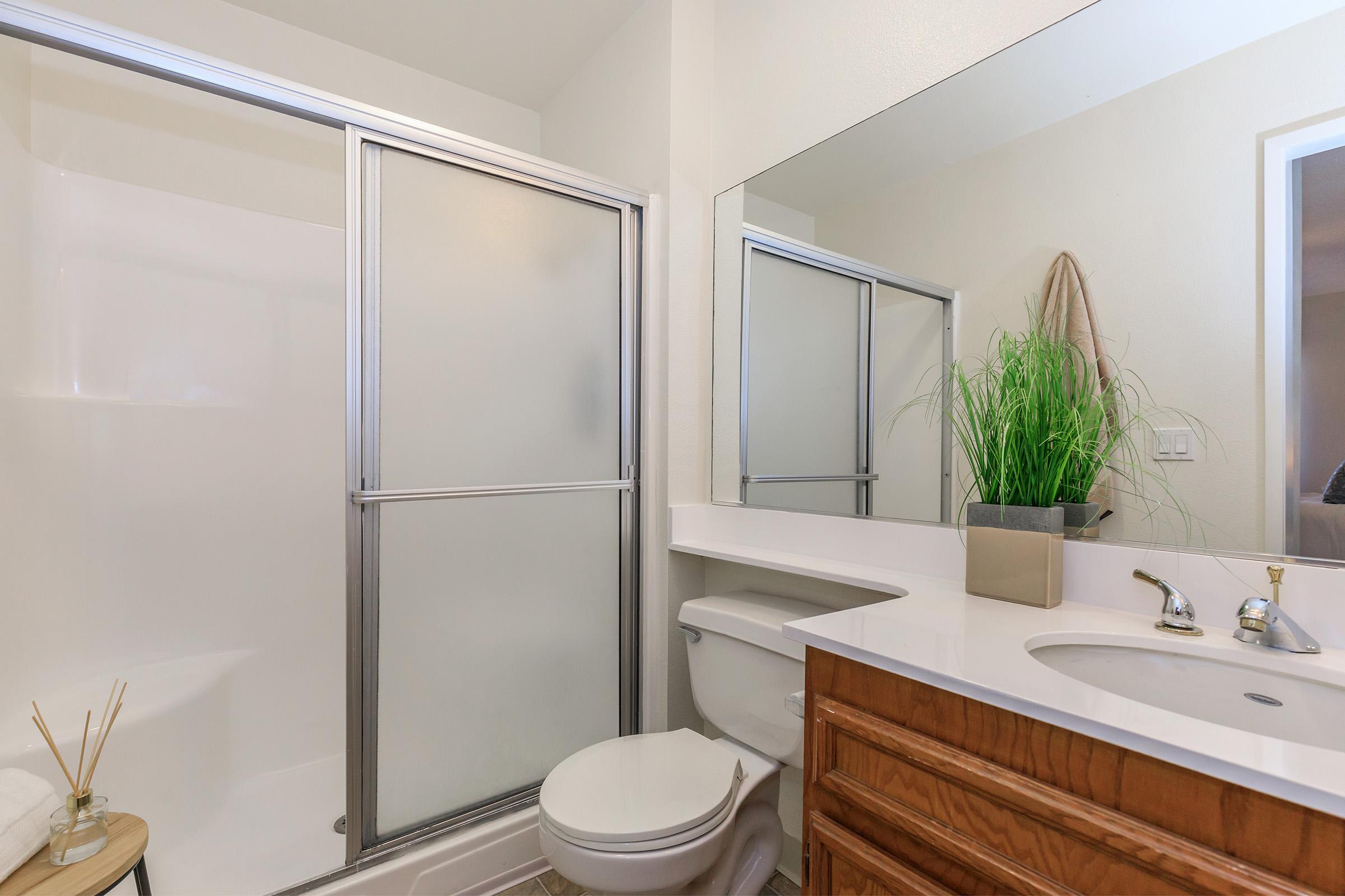 a large white tub next to a shower