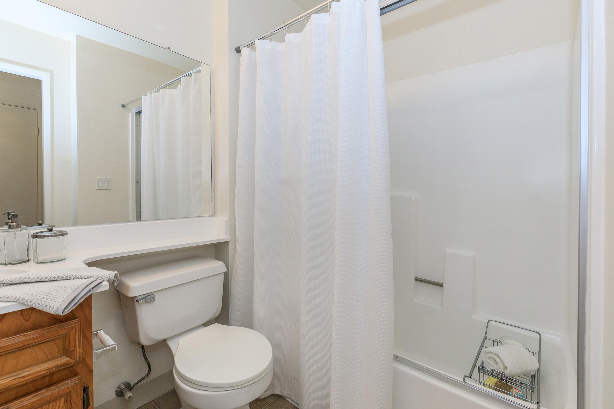 a white sink sitting next to a shower