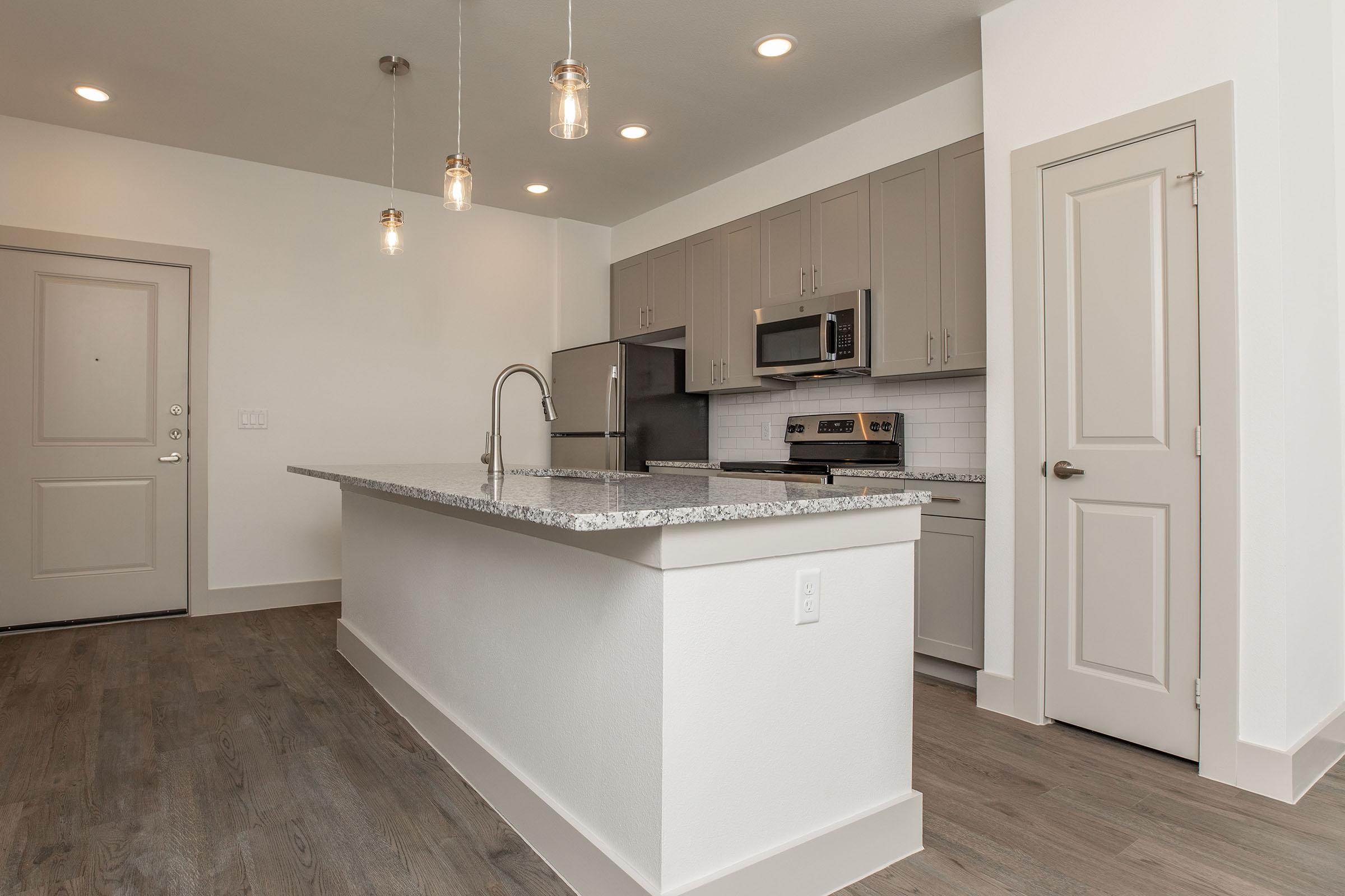 a kitchen with a sink and a refrigerator