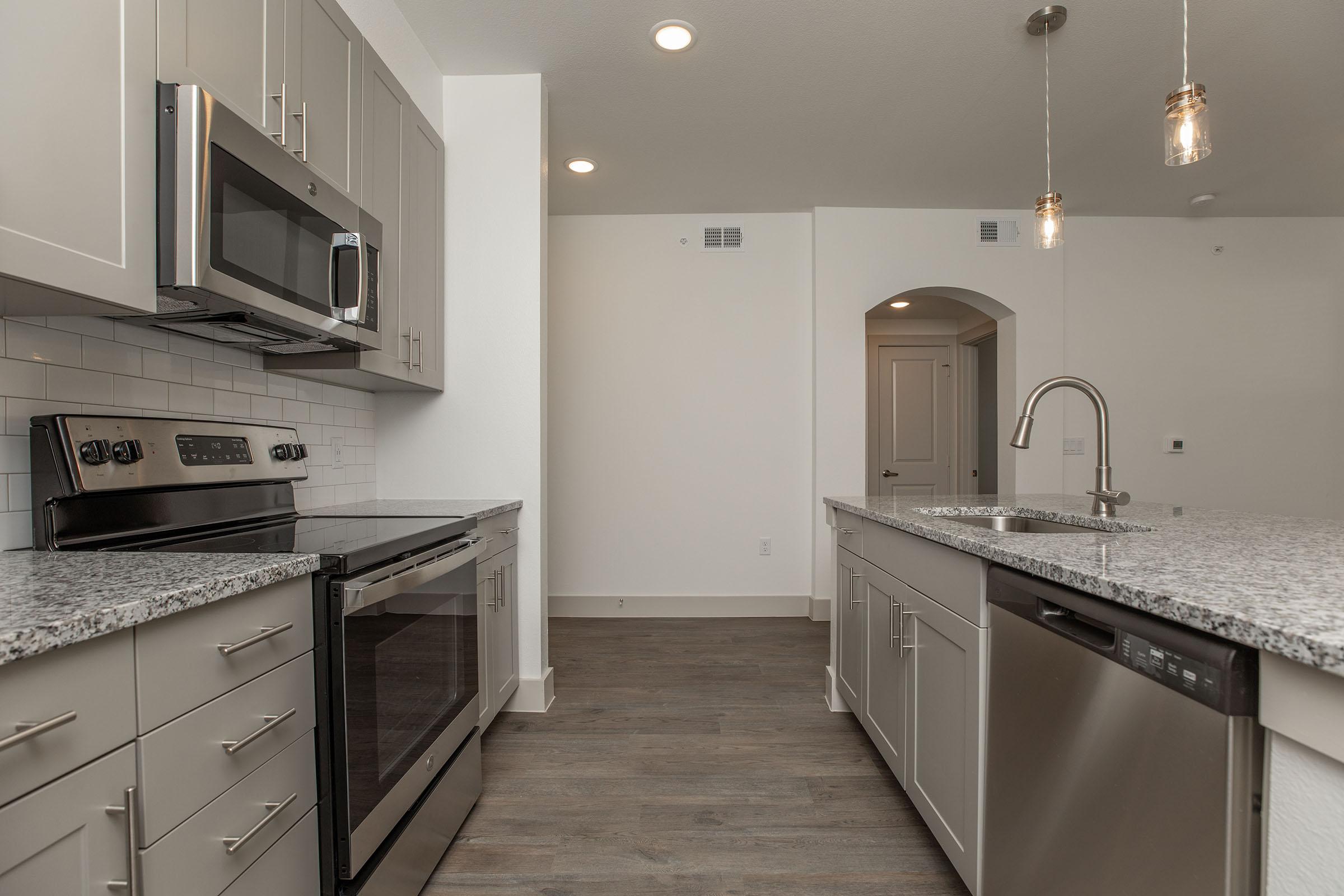 a kitchen with a stove sink and refrigerator