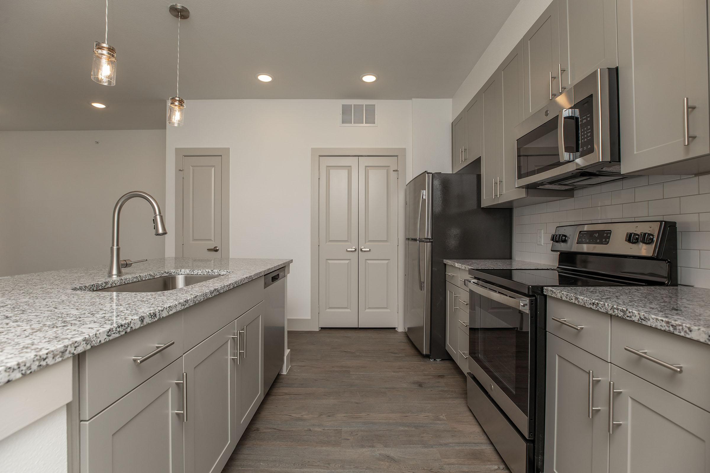a kitchen with a stove and a sink