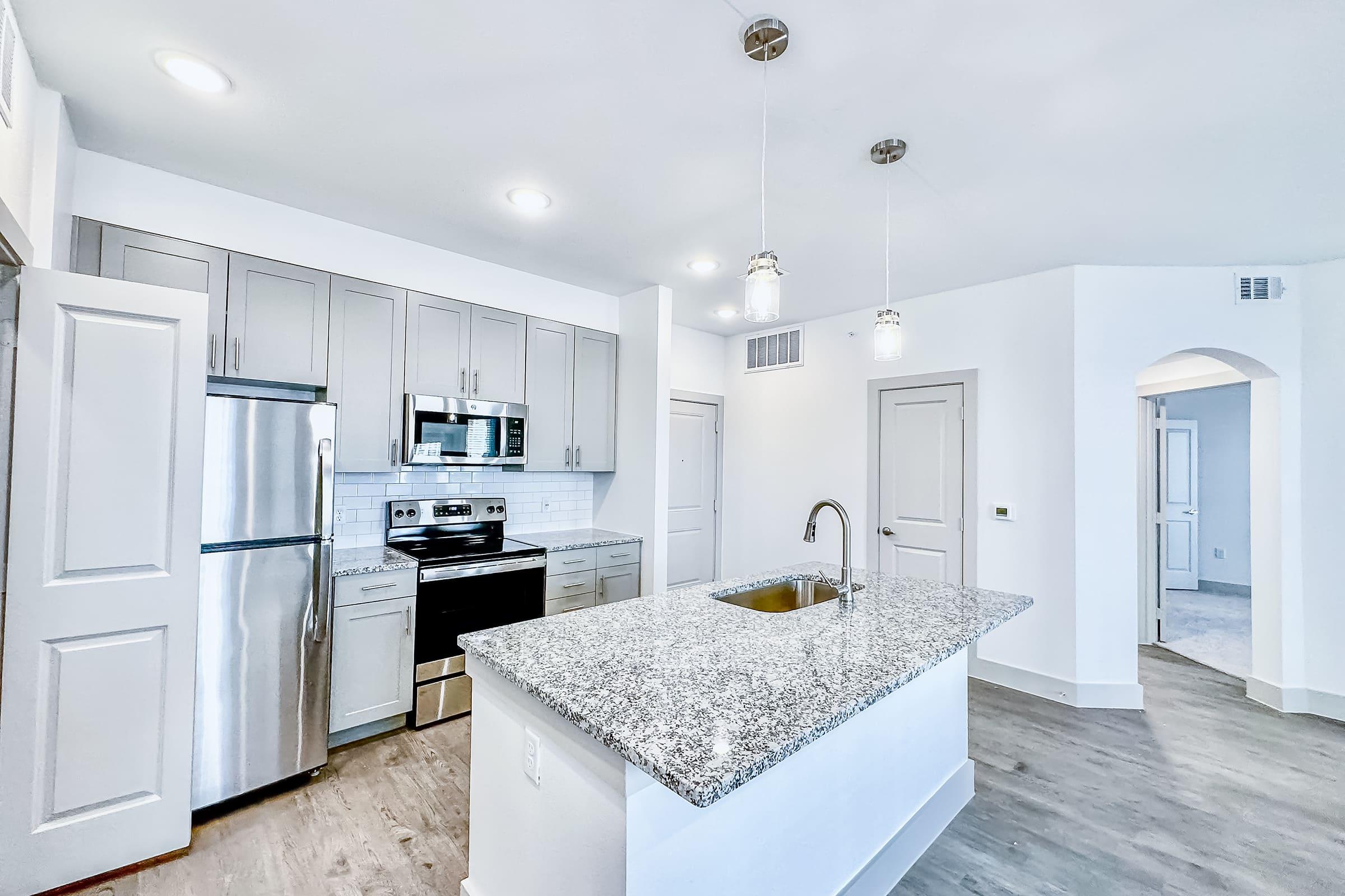 a kitchen with a sink and a counter in a room