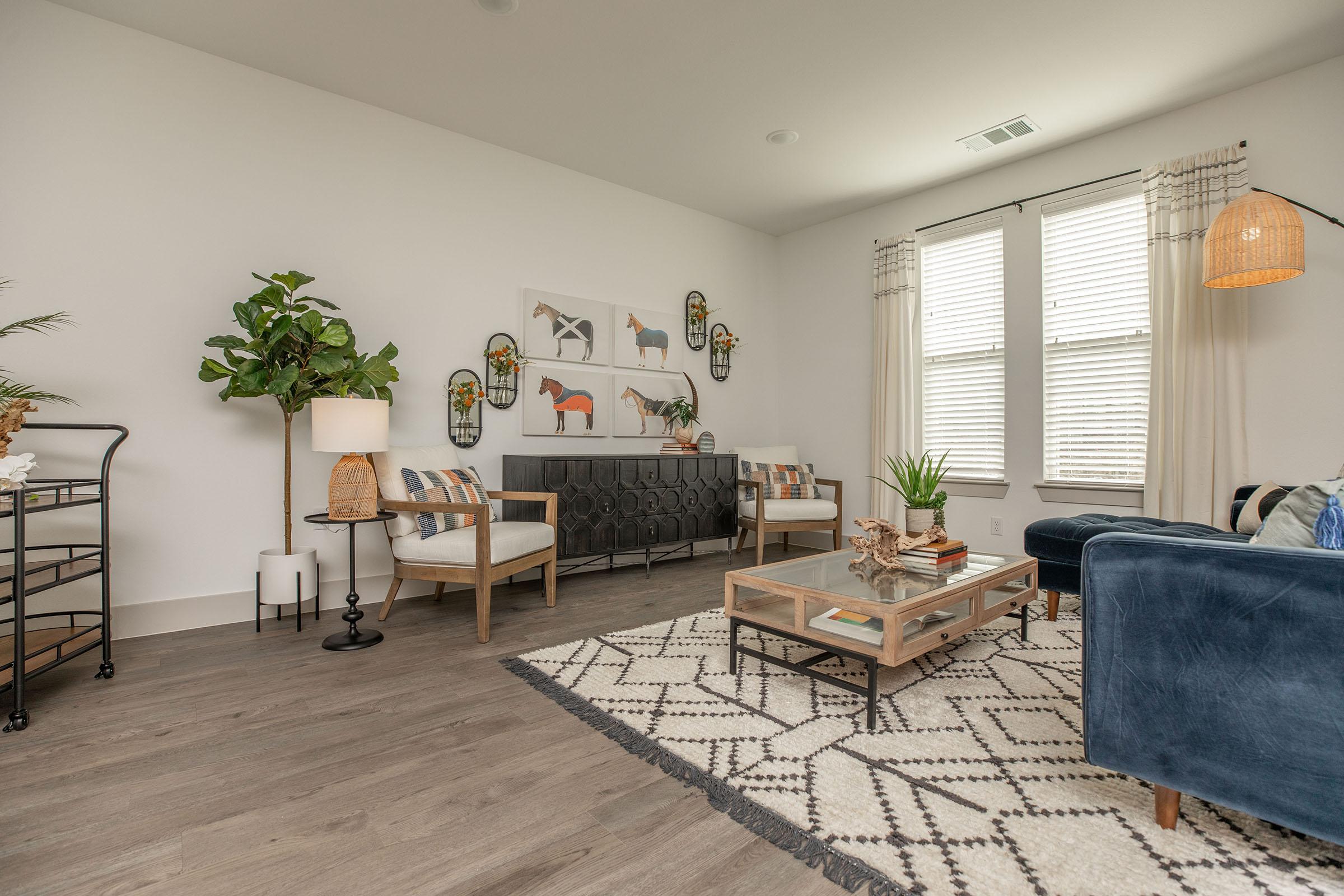 a living room filled with furniture and a large window