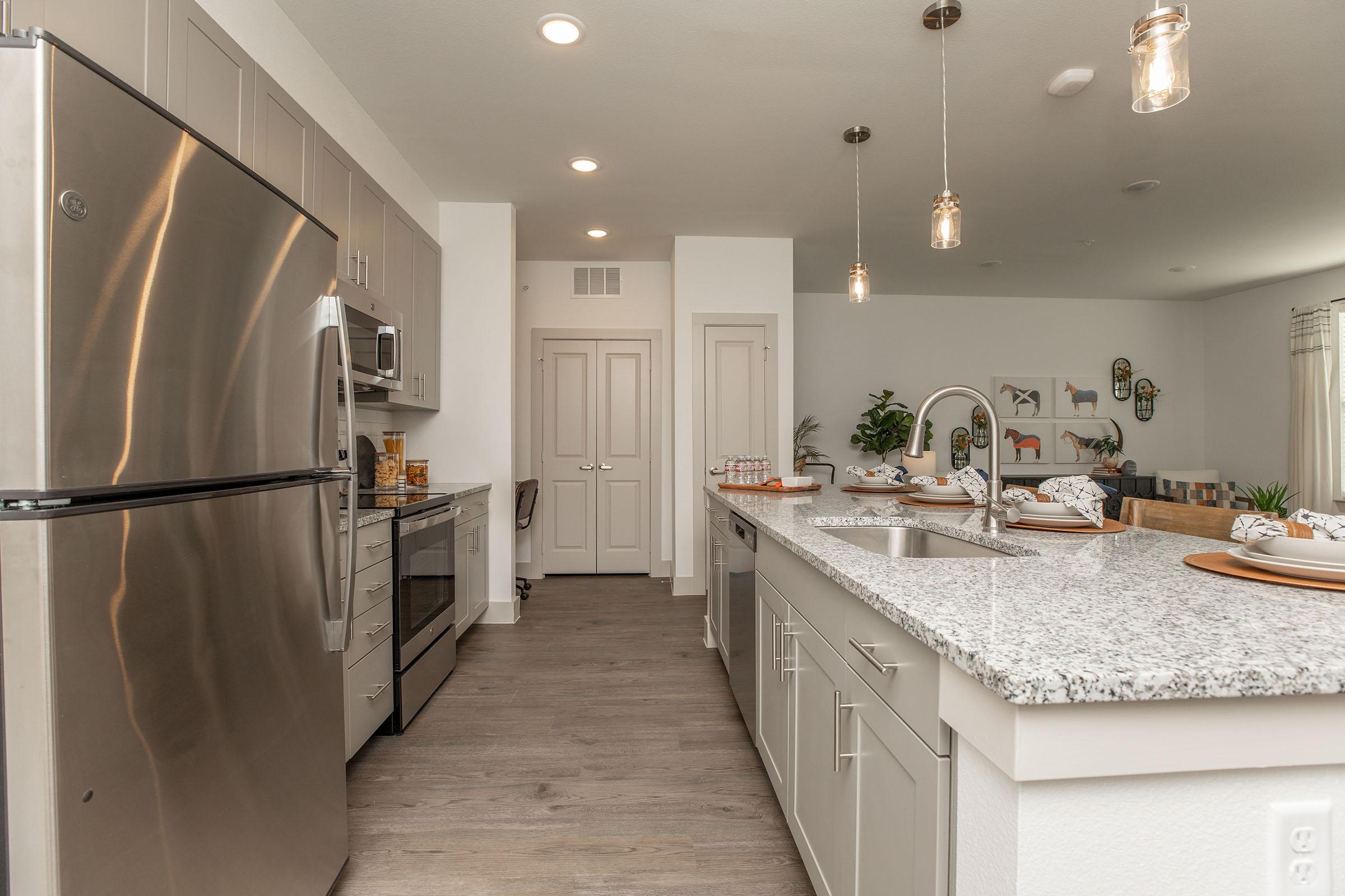 a kitchen with a sink and a refrigerator