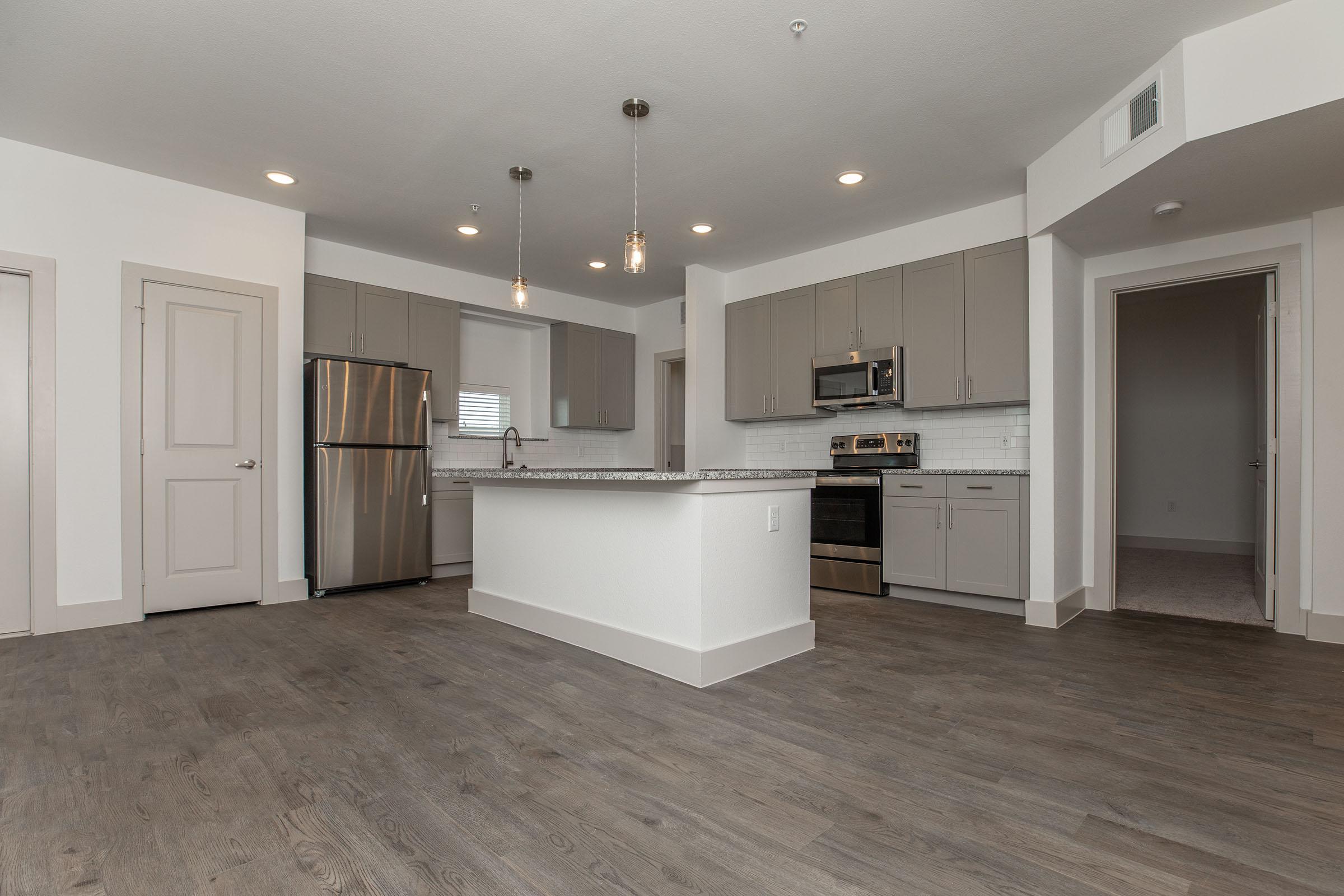 a kitchen area with a building in the background