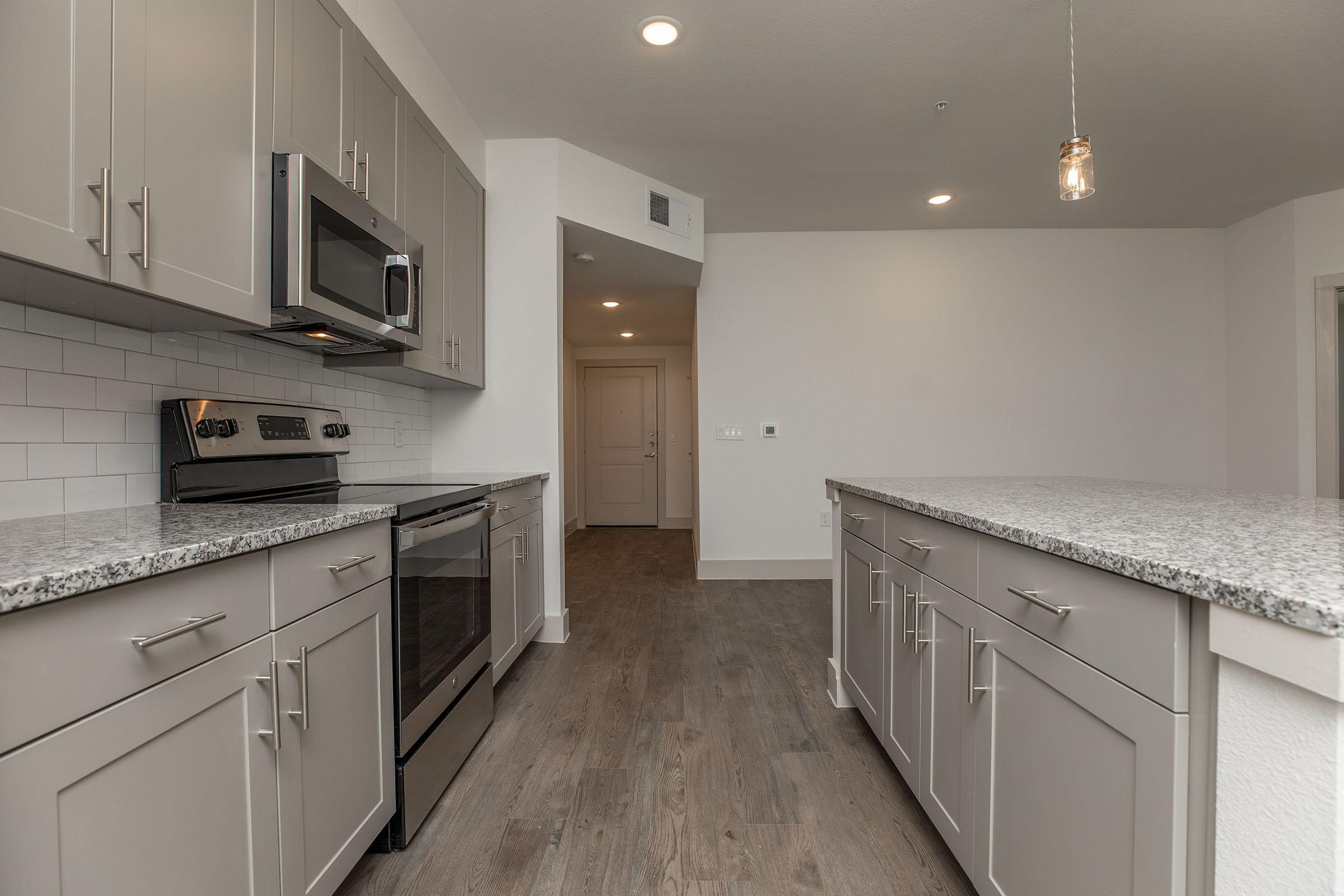 a large kitchen with stainless steel appliances