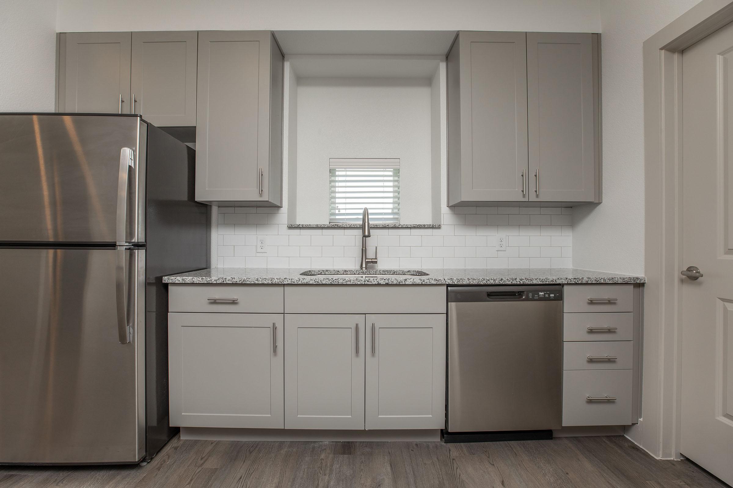 a kitchen with a stove and a refrigerator