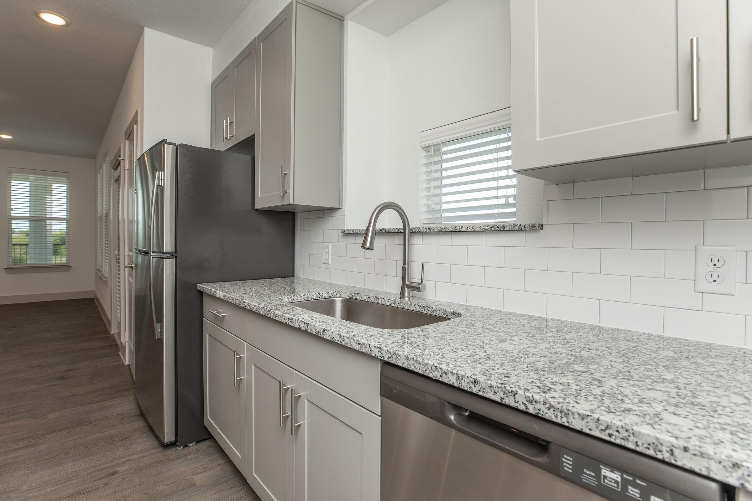 a kitchen with a tile floor