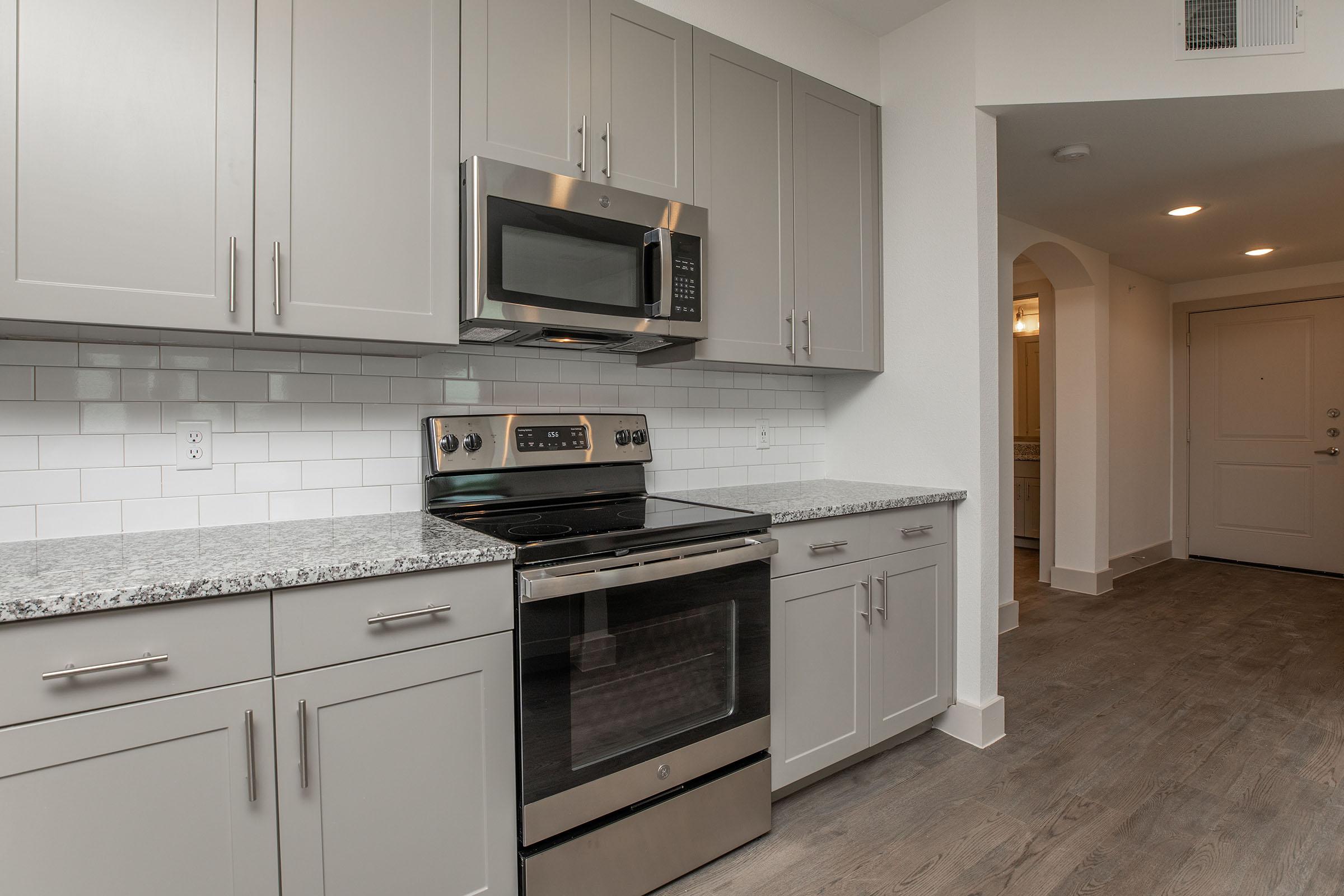a stove top oven sitting inside of a kitchen