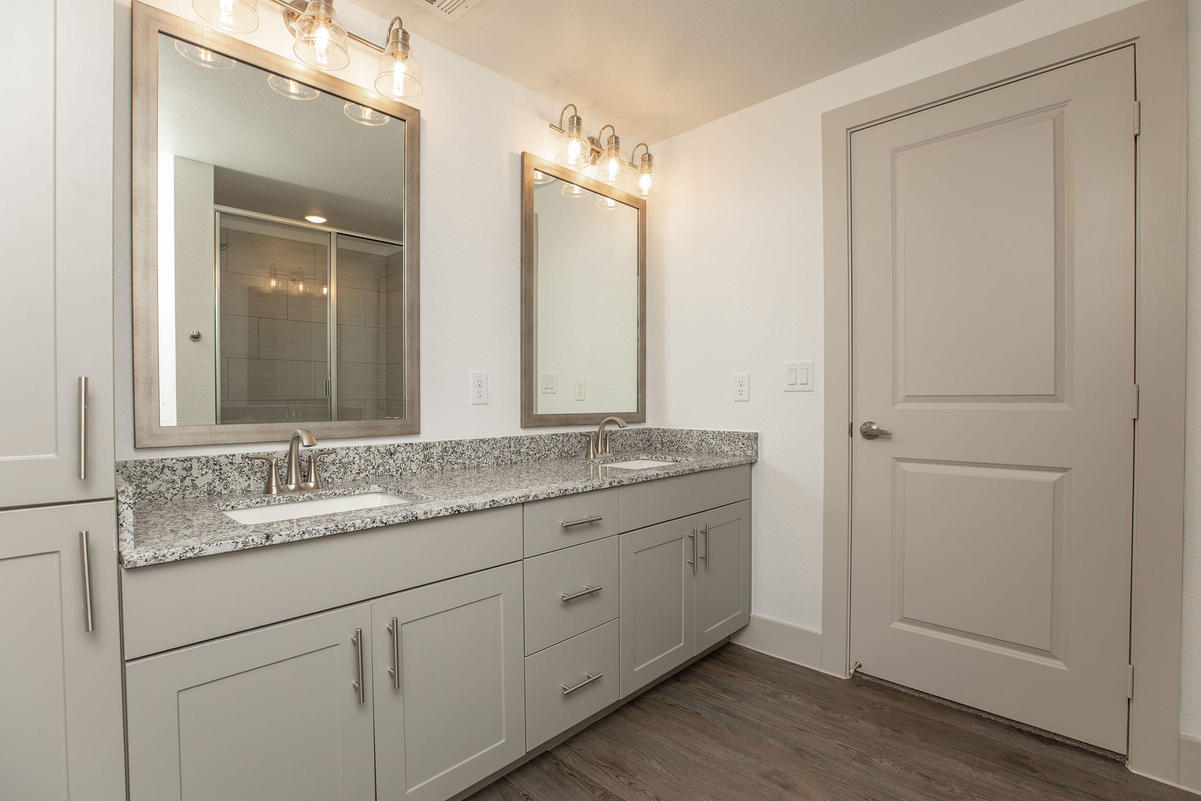 a kitchen with a sink and a mirror