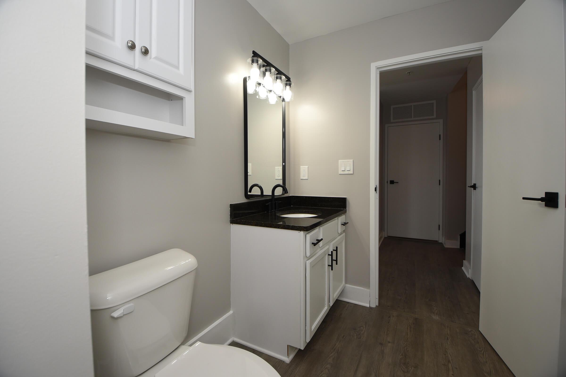 a room with a sink and a mirror