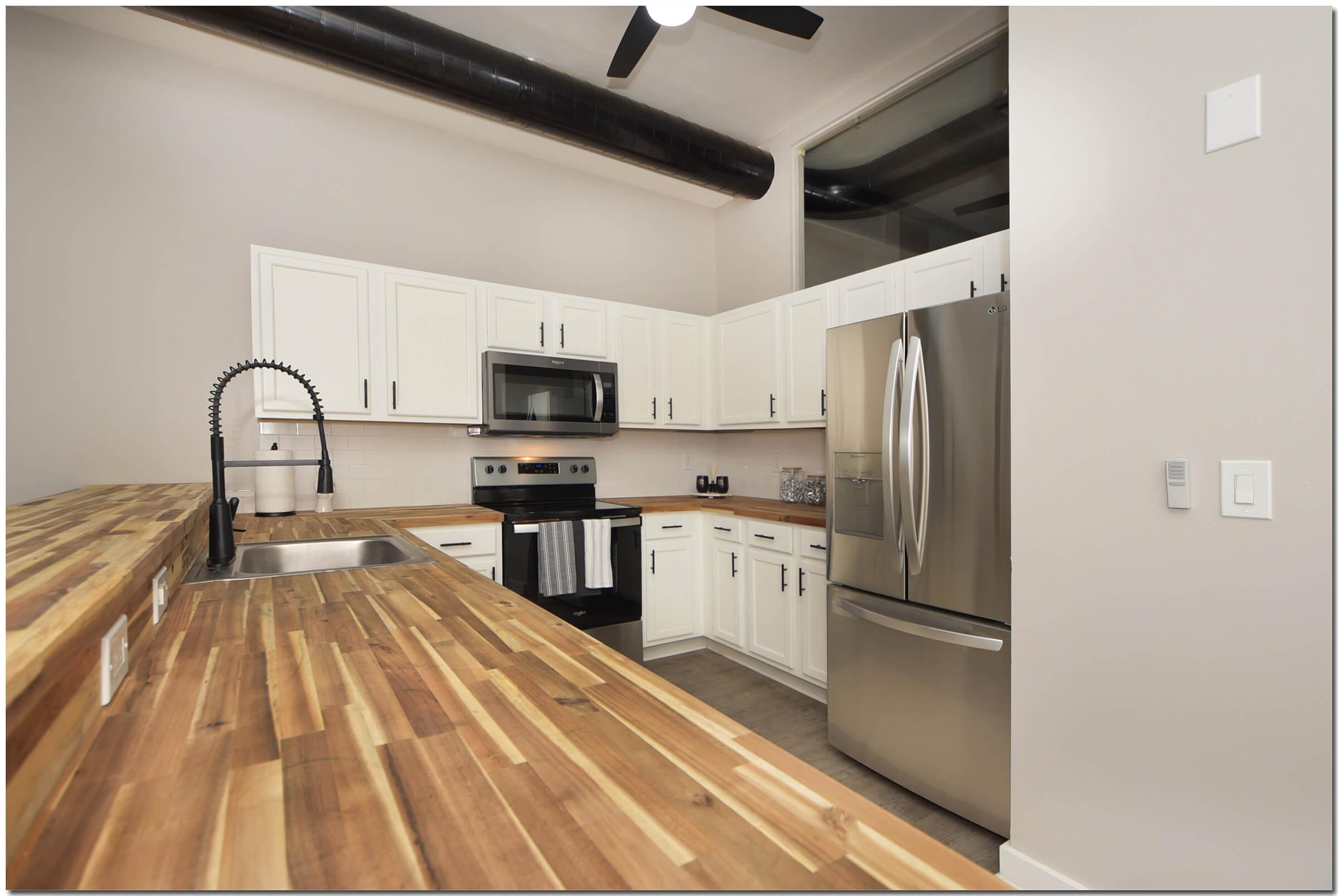a kitchen with stainless steel appliances and wooden cabinets