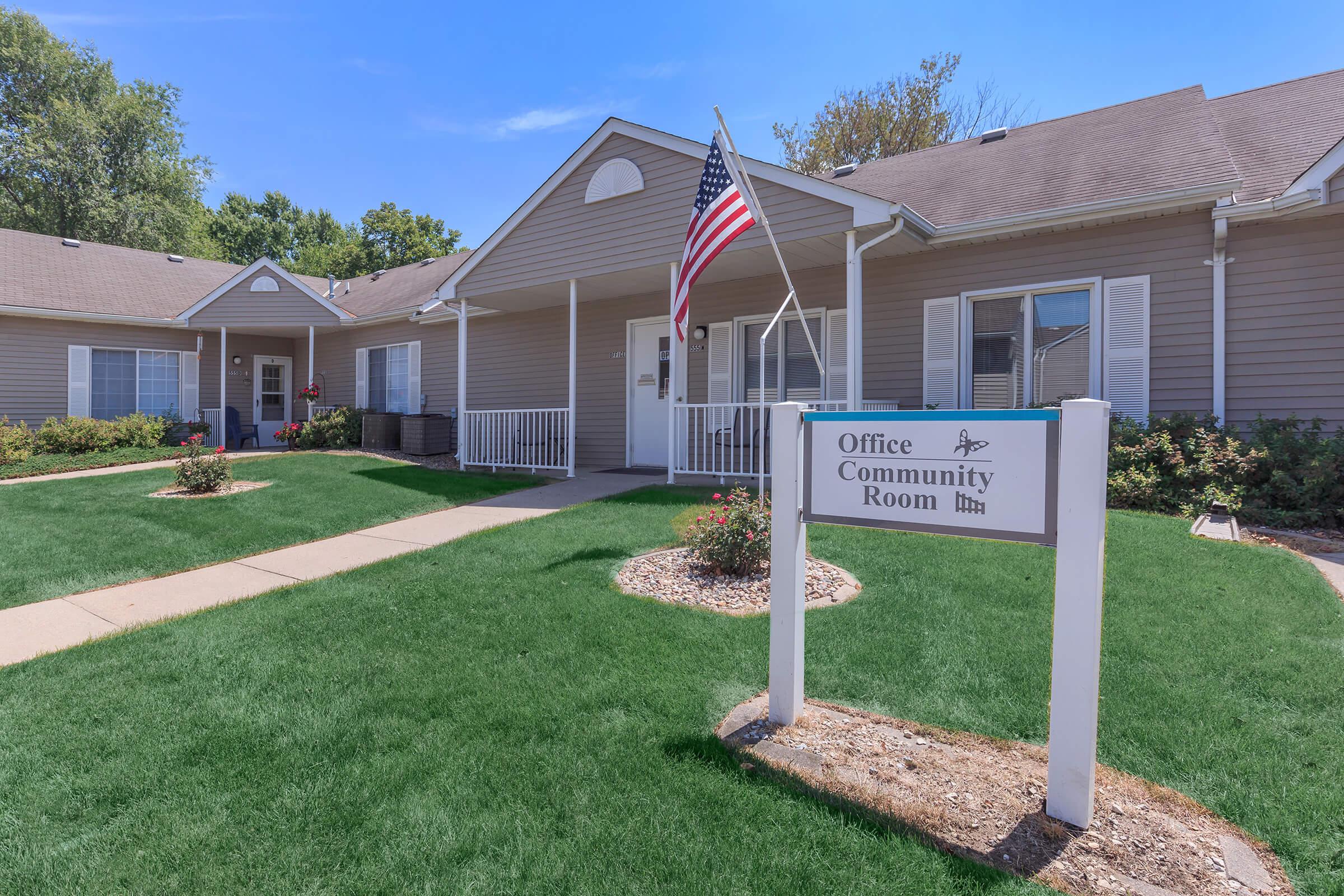 a house with a lawn in front of a building