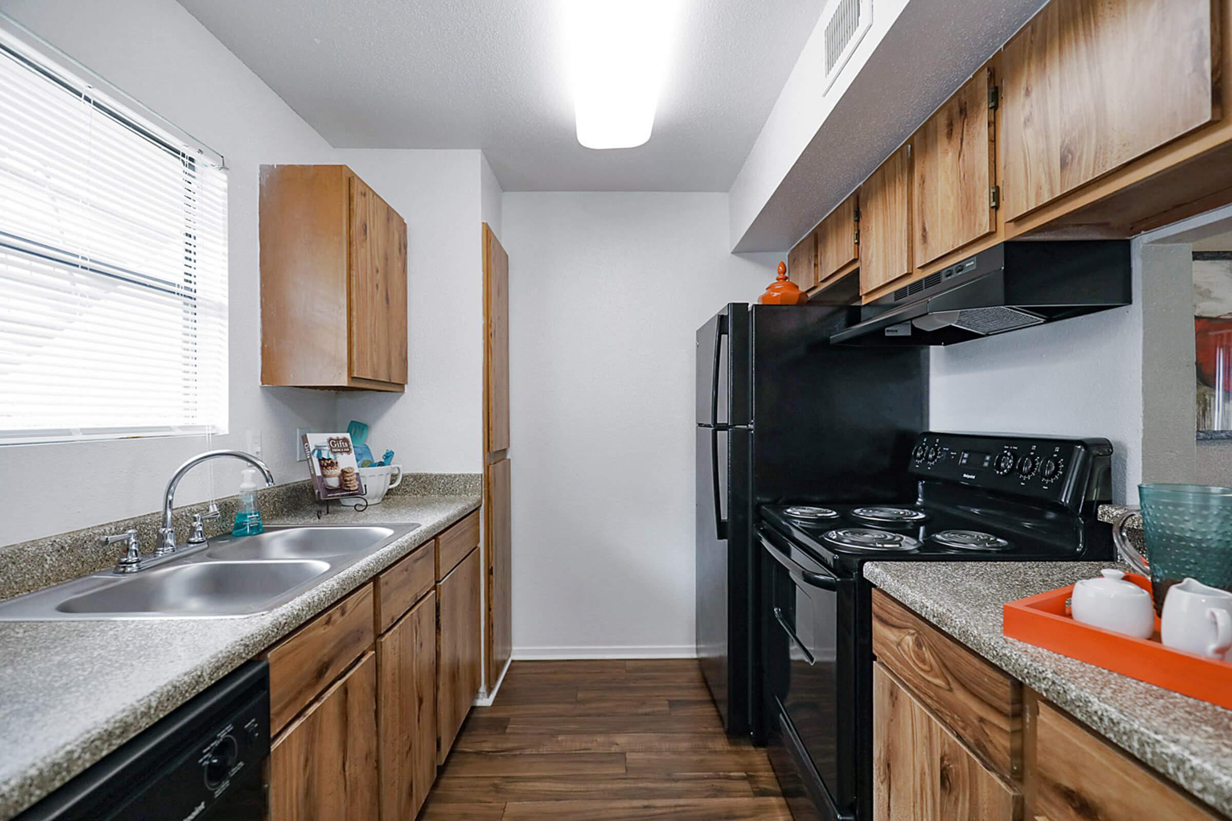 a modern kitchen with stainless steel appliances and wooden cabinets