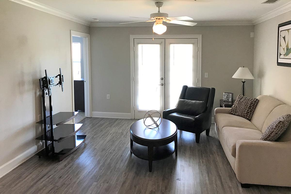 a living room filled with furniture and a large window