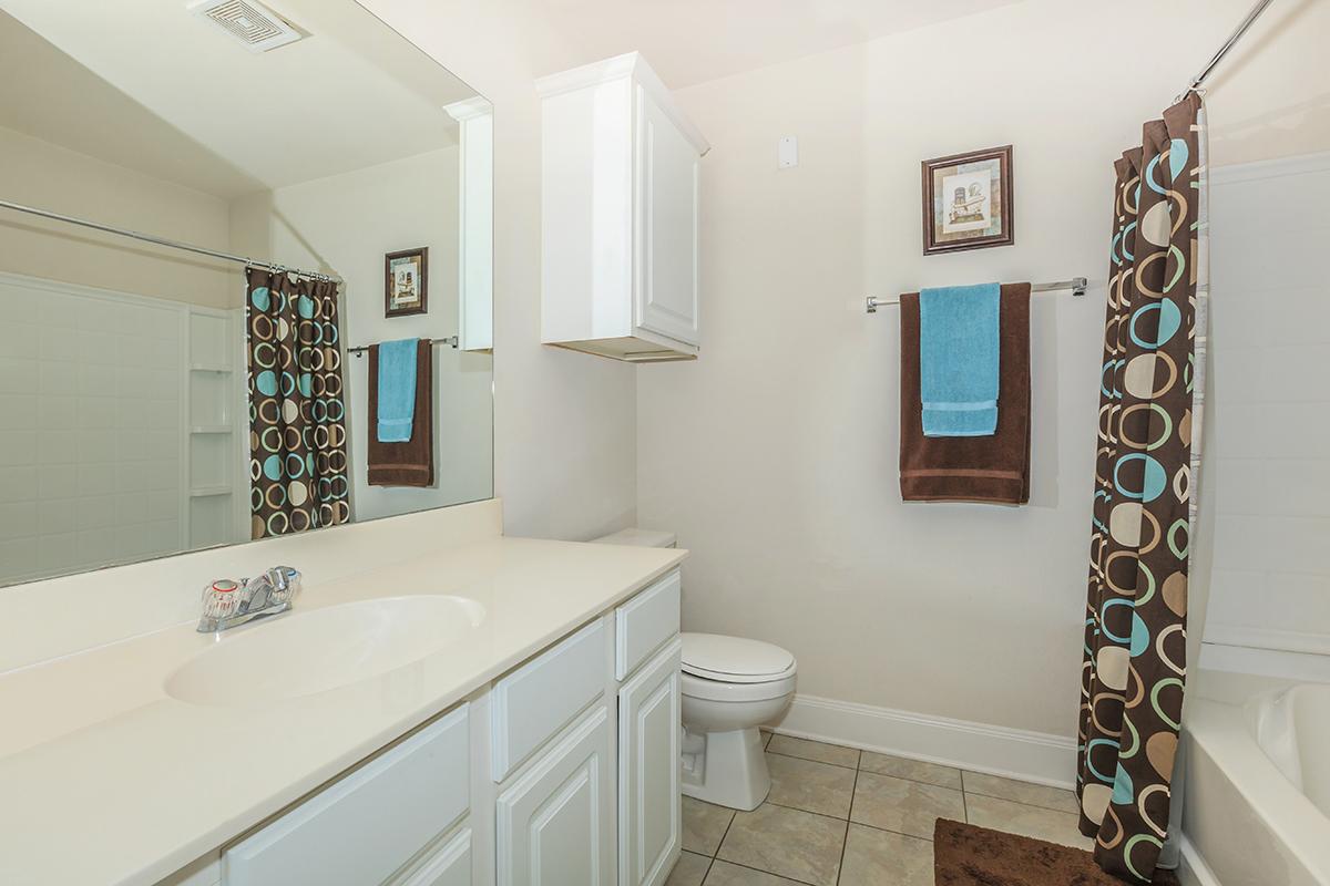 a large white tub next to a sink