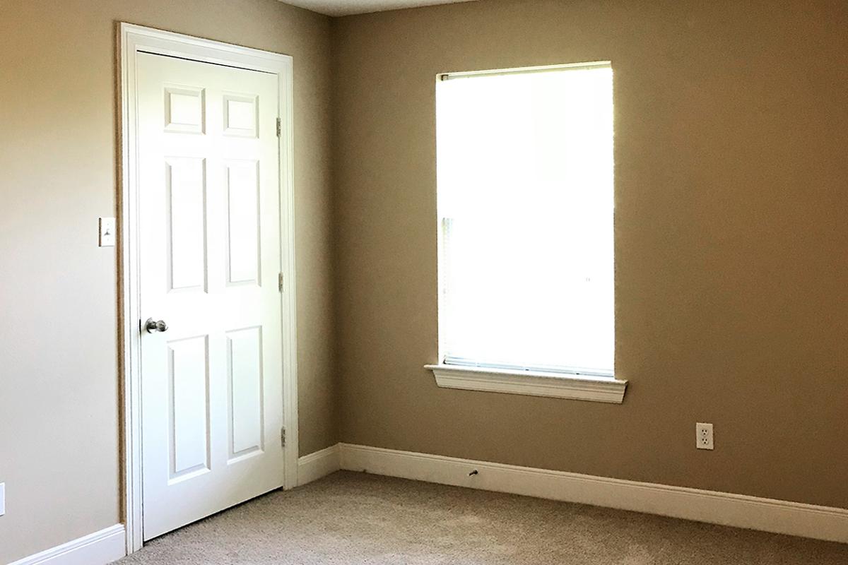 a white sink sitting under a window