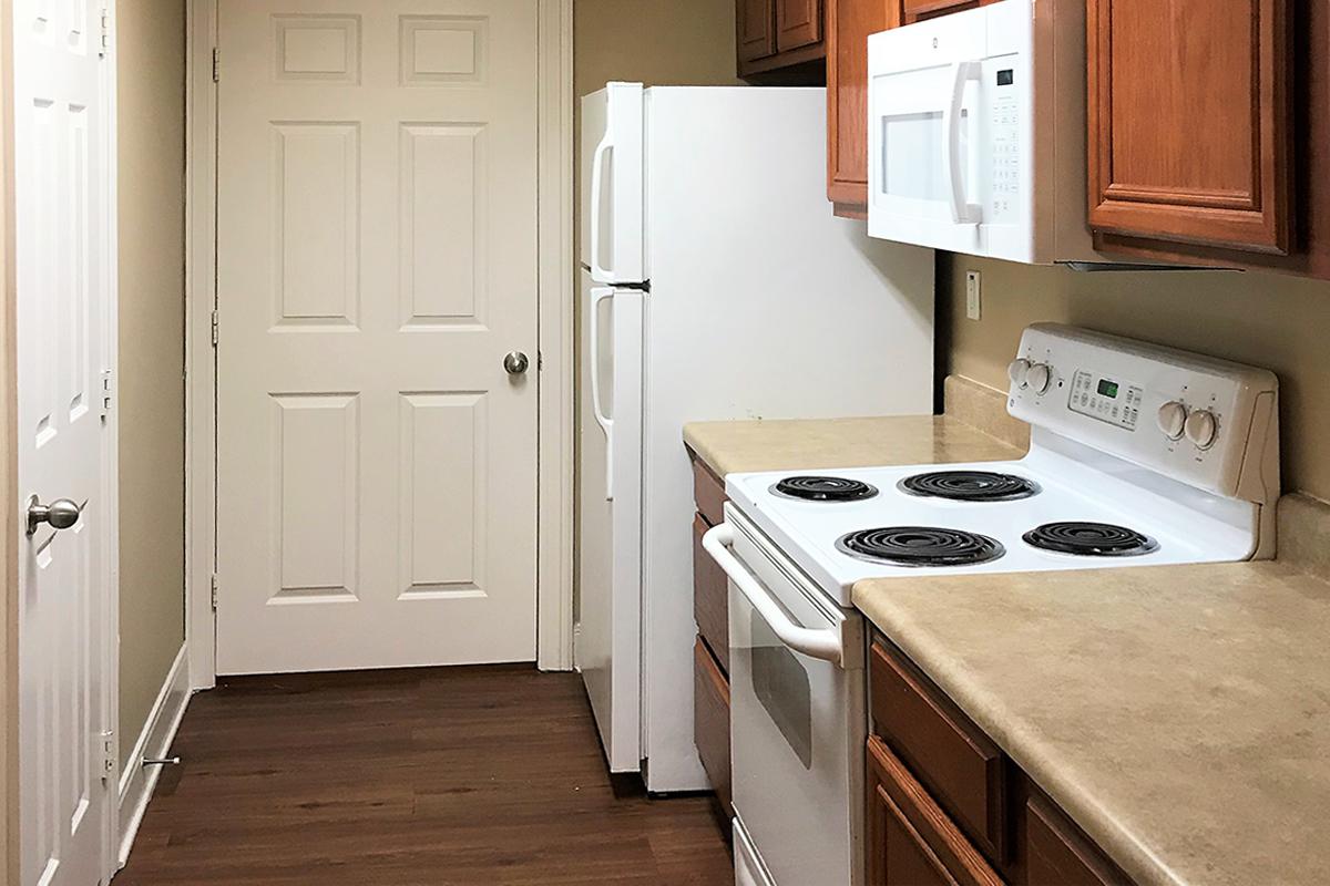 a kitchen with a white stove top oven sitting inside of a refrigerator