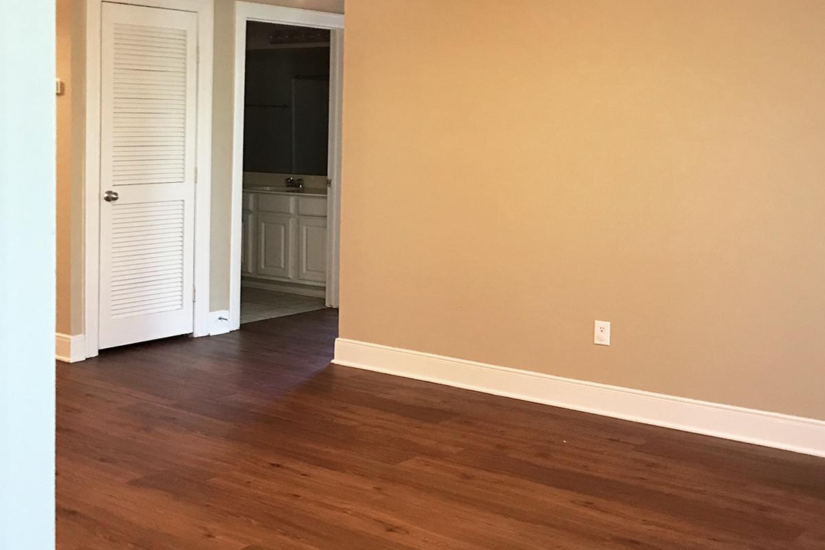 a close up of a hard wood floor next to a door