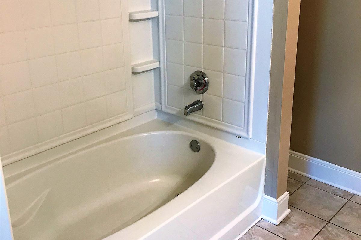 a white tub sitting next to a sink