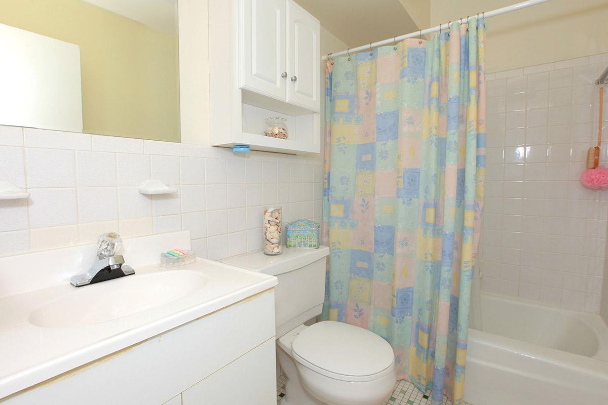 a white tub sitting next to a sink