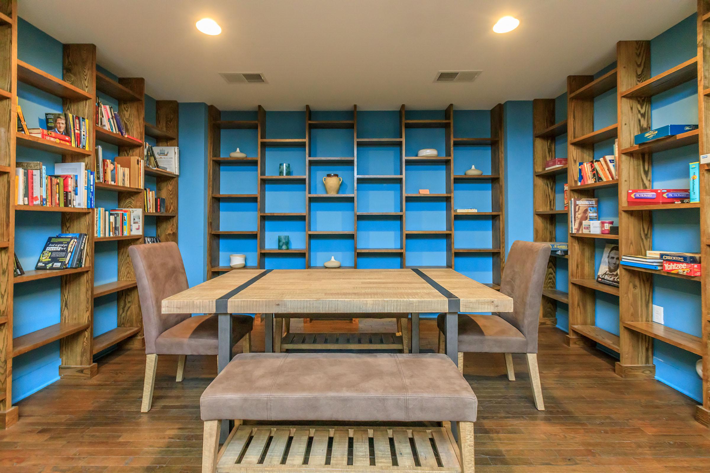 a dining room table and chairs in a library