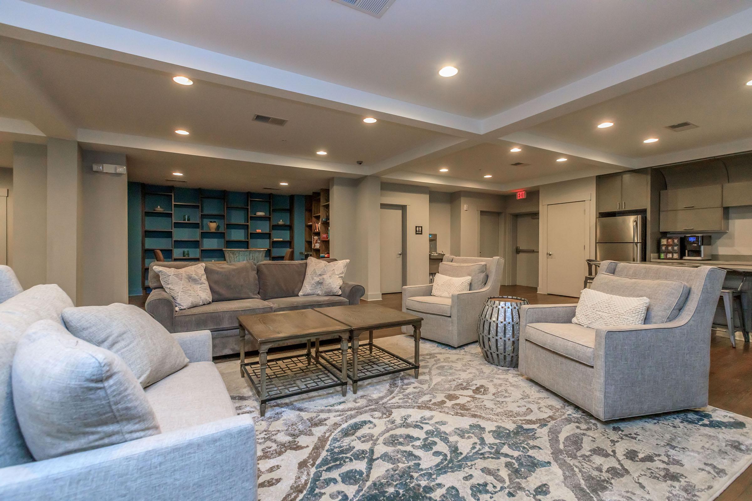 a living room filled with furniture and a large window