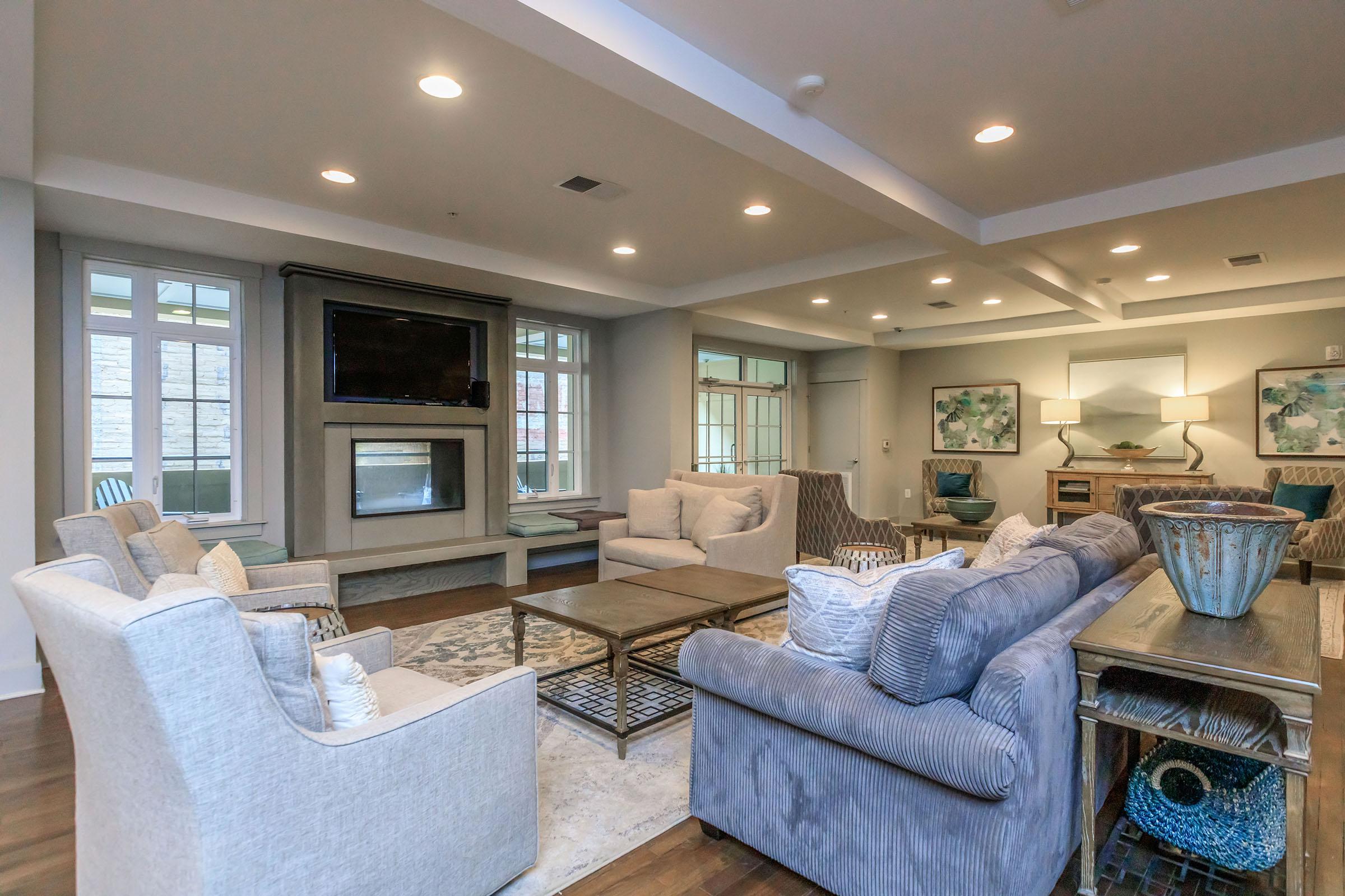 a living room filled with furniture and a large window