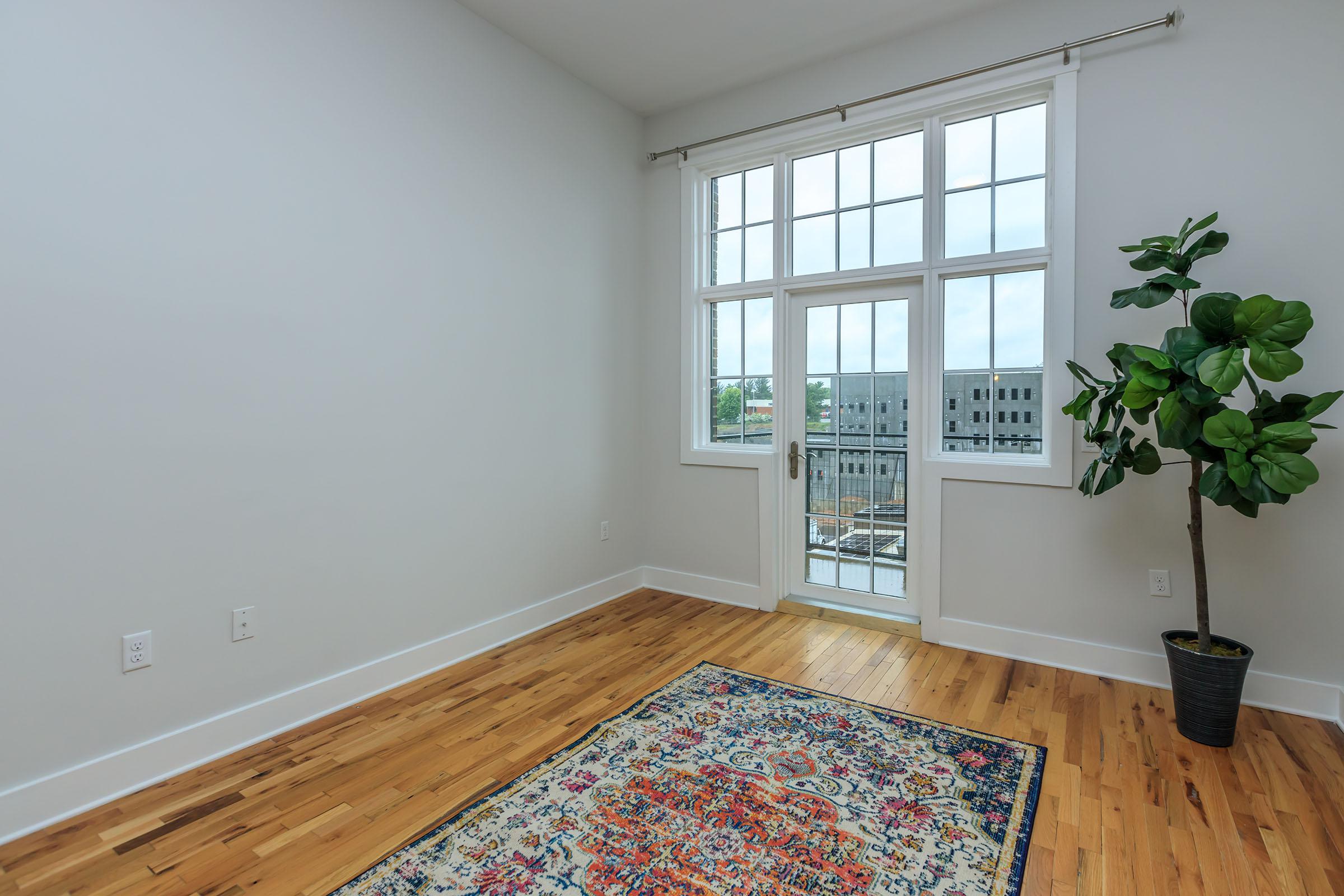 a bedroom with a large window