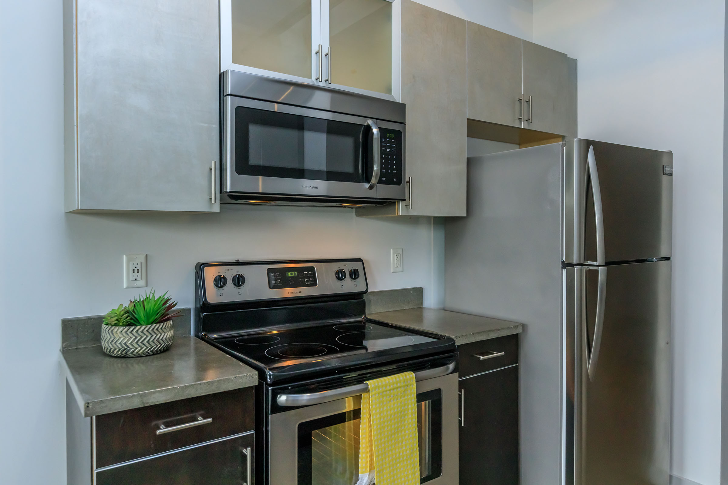 a stove top oven sitting inside of a kitchen with stainless steel appliances