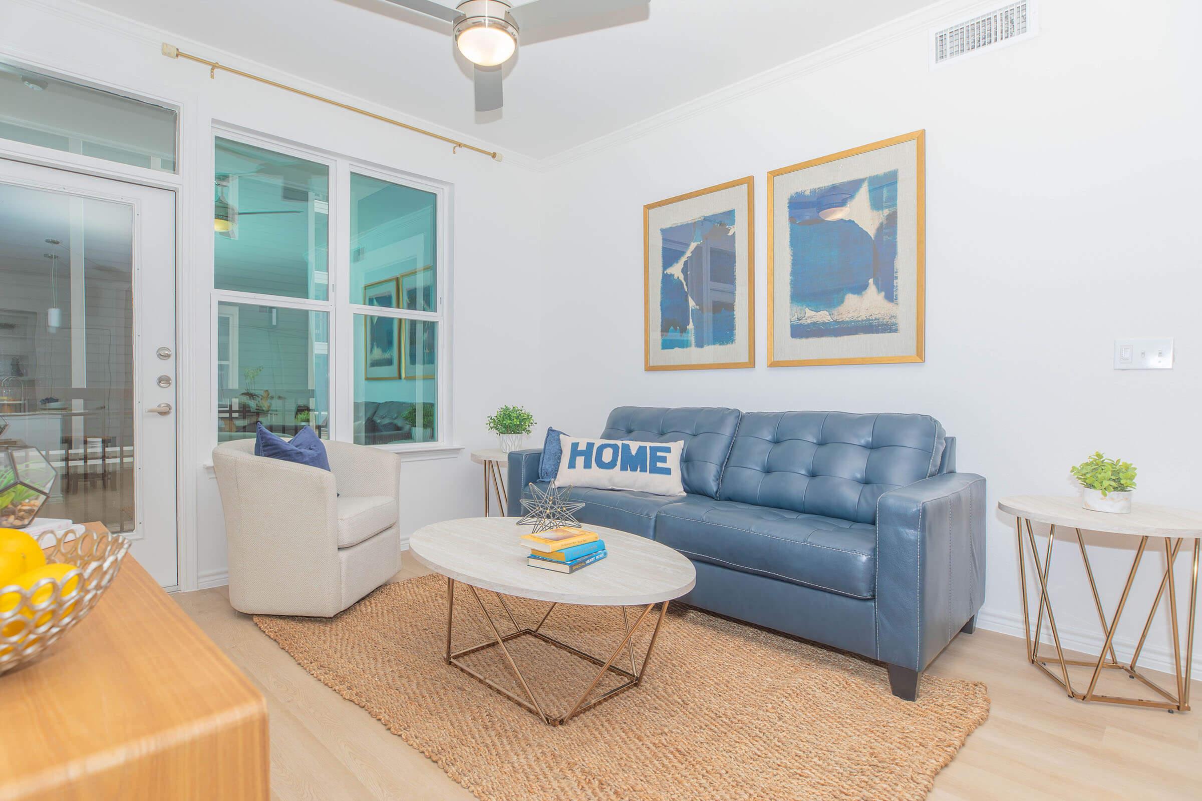 a living room filled with furniture and a large window