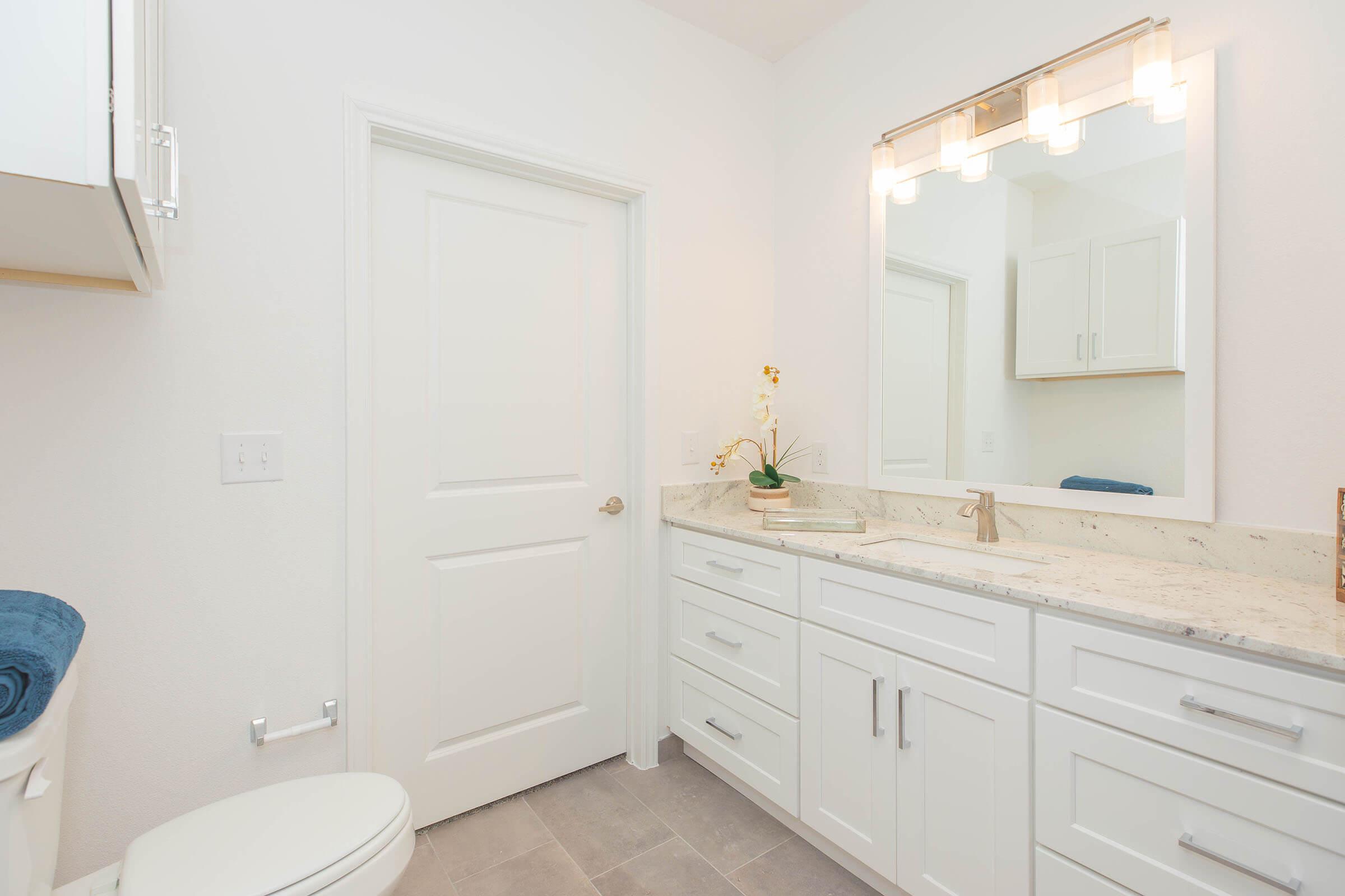 a kitchen with a sink and a mirror