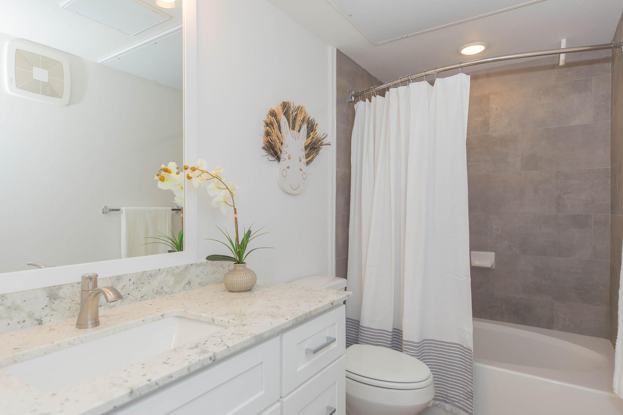 a room with a sink and a shower curtain