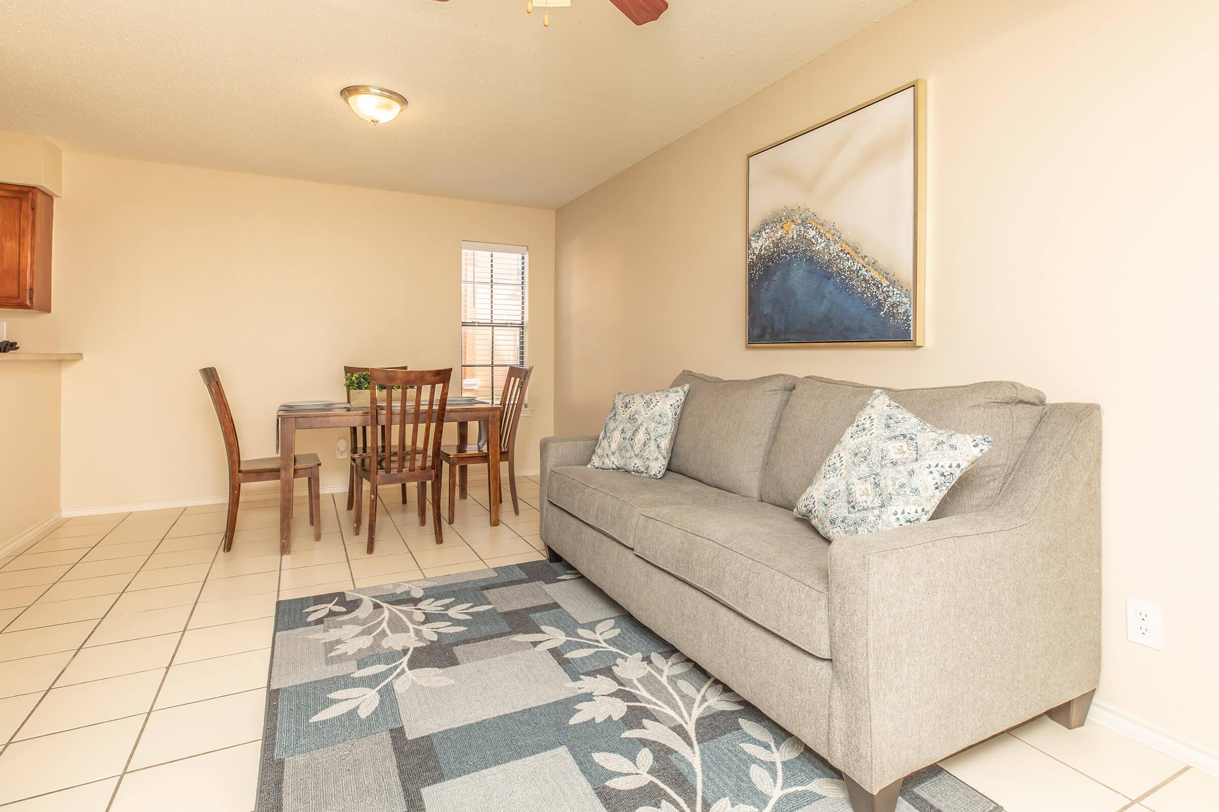 a living room filled with furniture and a rug